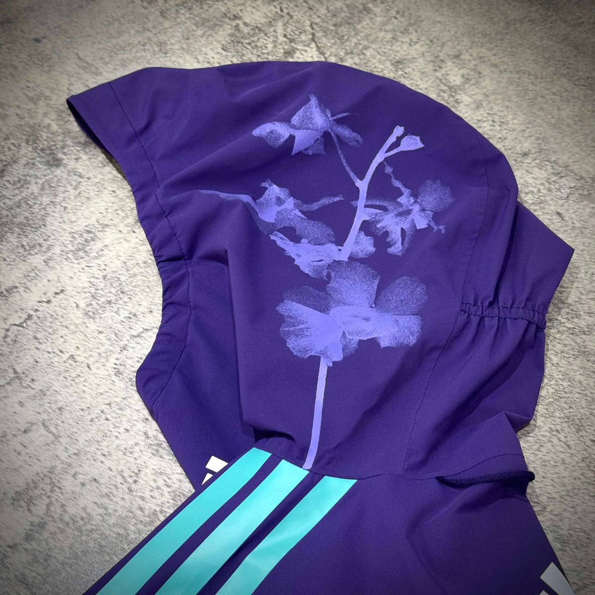 Mercedes-AMG Petronas Formula 1 Team Vanda Bloom Rain Jacket showing floral design on hood.