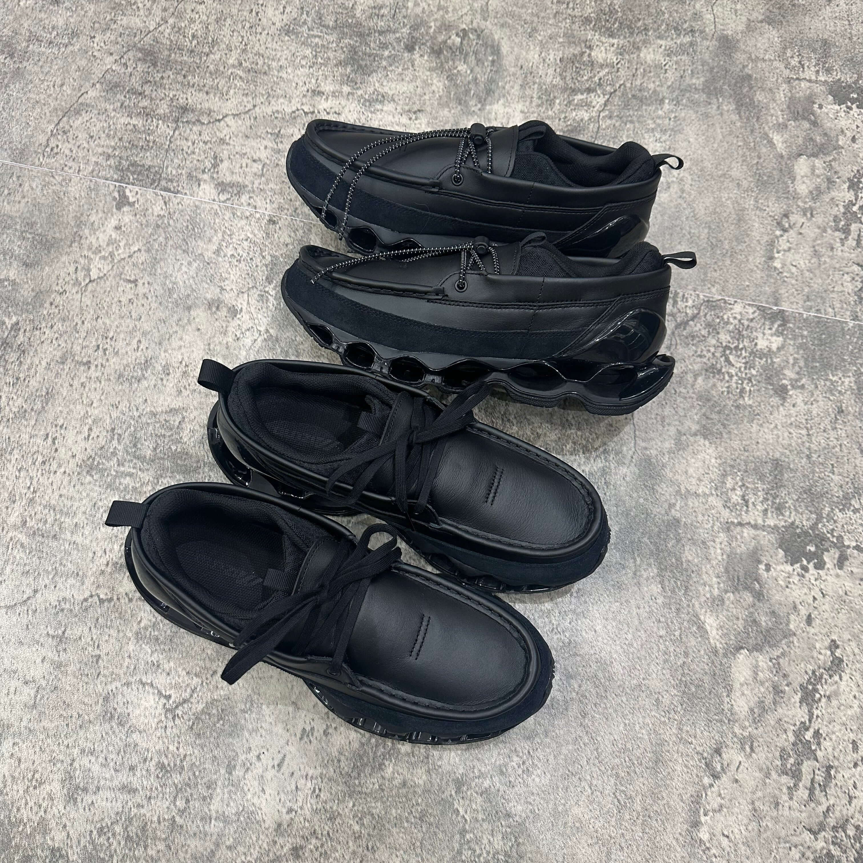 Mizuno Wave Prophecy Moc 2026 - All Black sneakers displayed from above on a textured surface.