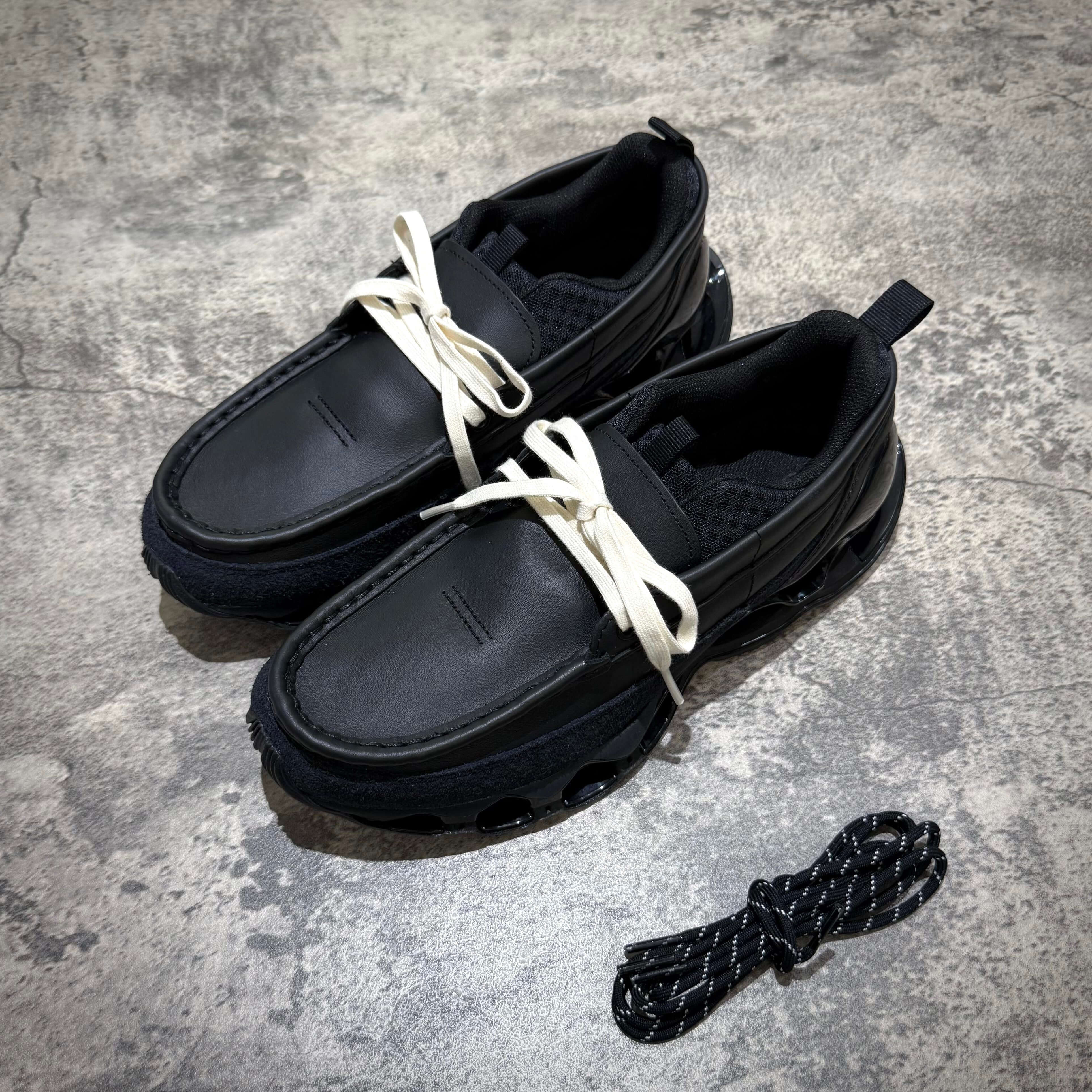 Mizuno Wave Prophecy Moc - Black shoes with white laces and unique design on a textured surface.