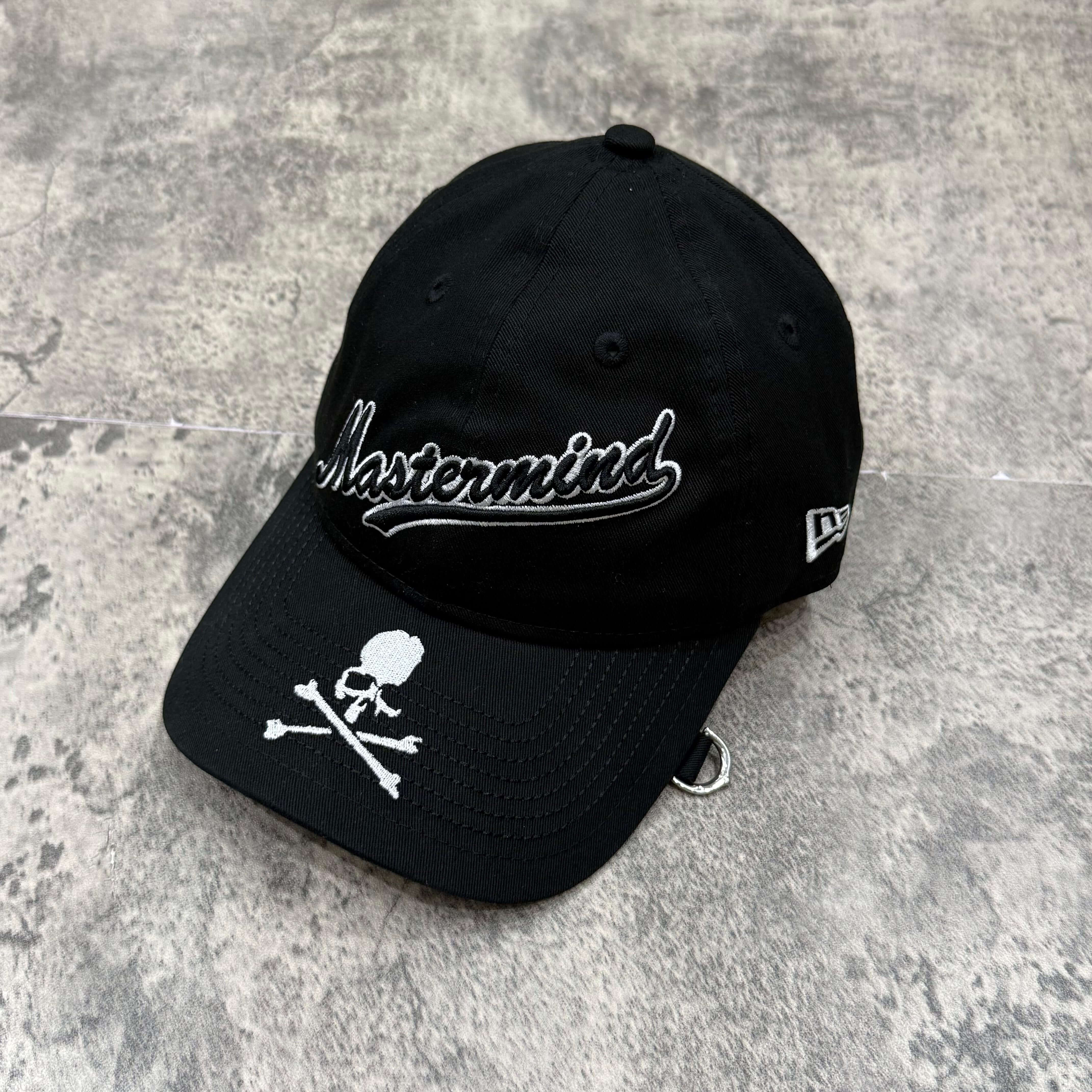 New Era x Mastermind cap featuring black design and skull logo on the front.