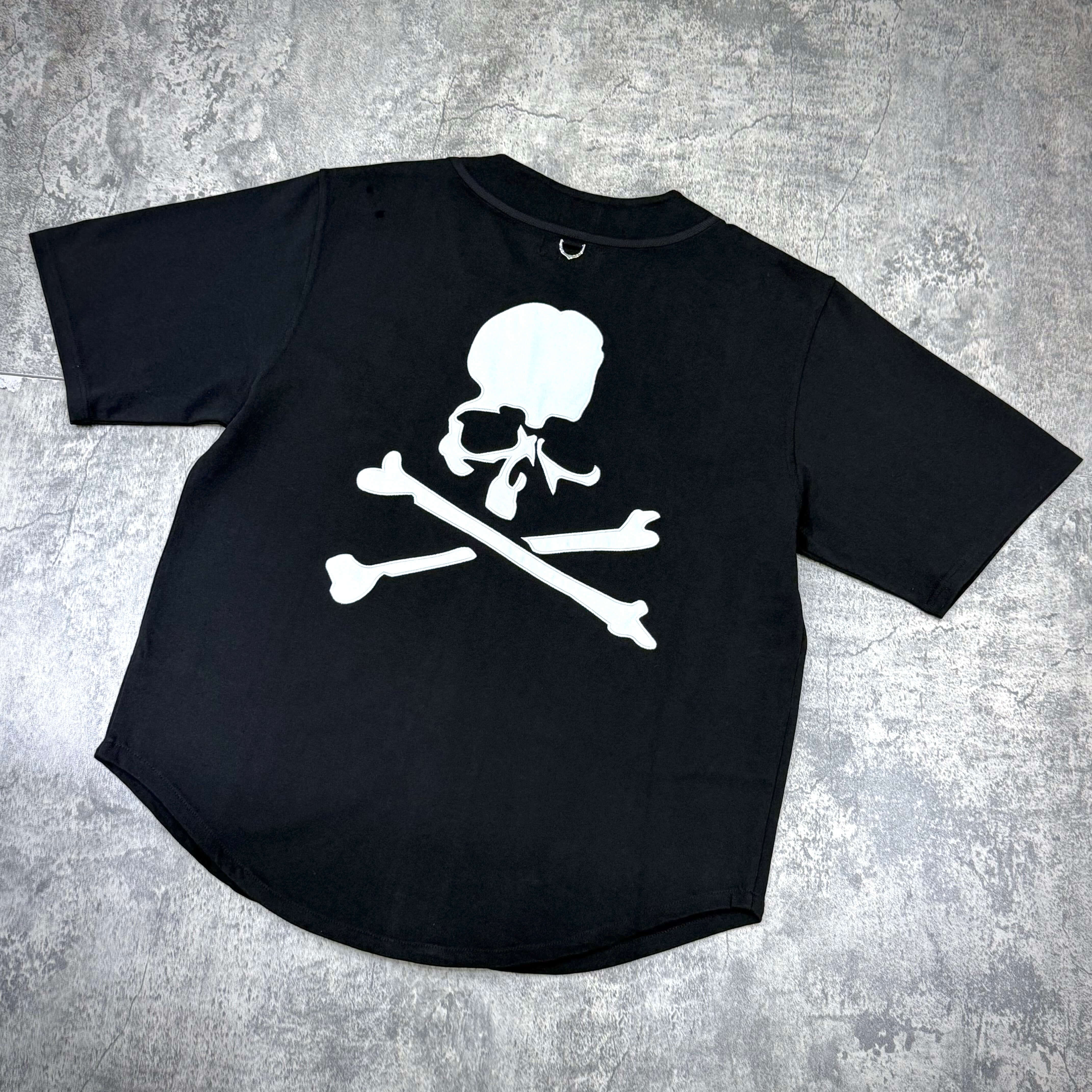 New Era x Mastermind black baseball shirt featuring large white skull and crossbones design on the back.