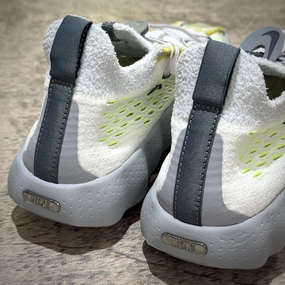 Nike Mind 002 Flyknit - Wolf Grey shoes featuring sleek design and modern material texture.