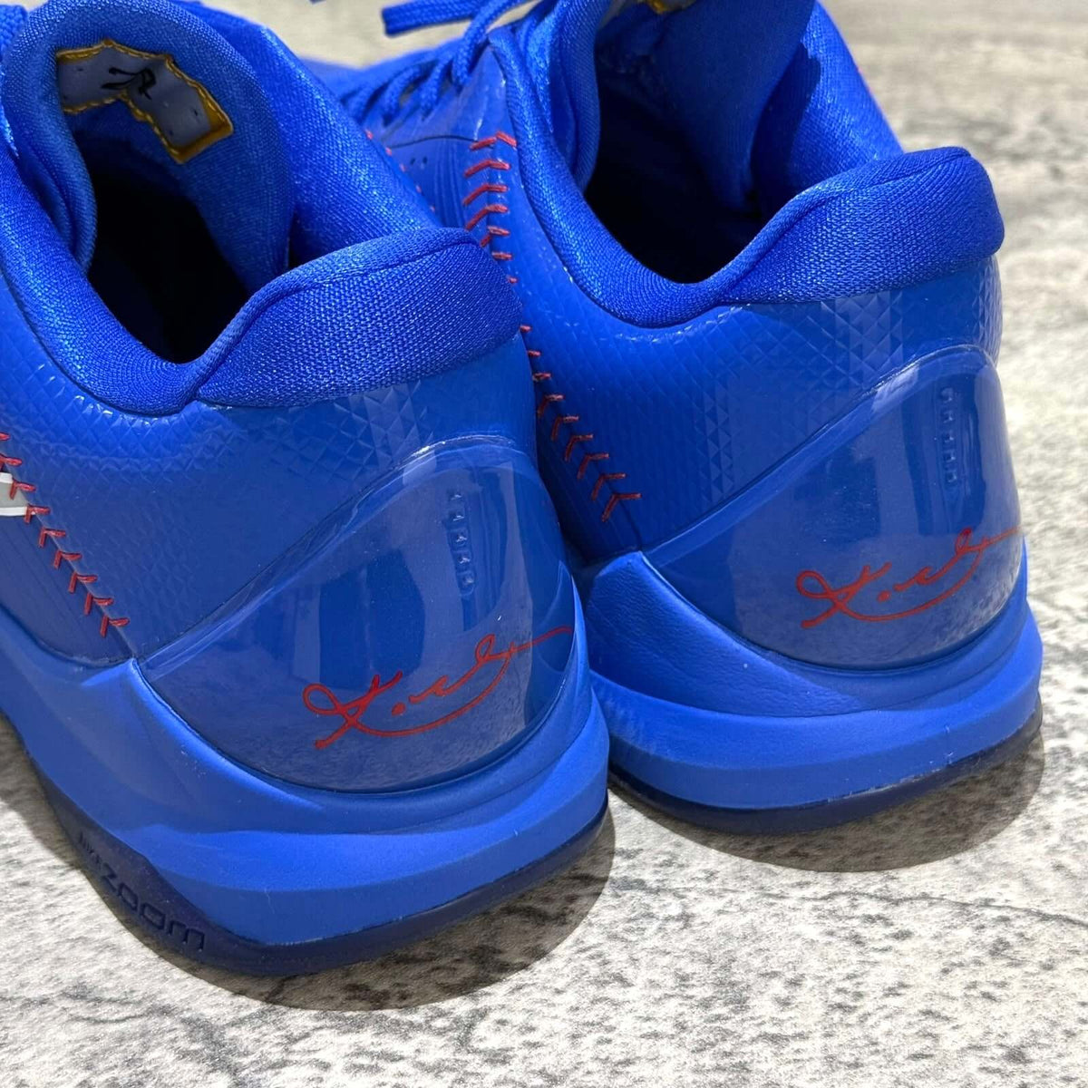Close-up of the heel of Nike Zoom Kobe 5 Protro Dodgers IO6256-400 sneaker, showcasing vibrant blue color and signature details.