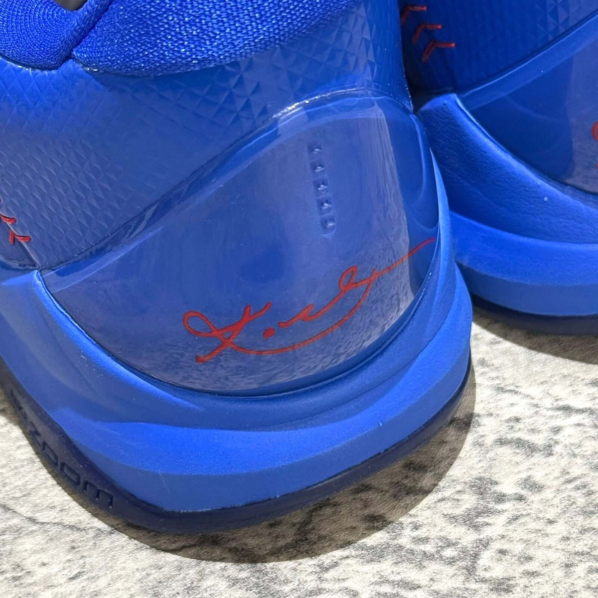 Close-up of the Nike Zoom Kobe 5 Protro Dodgers showing signature detail on blue sneaker.