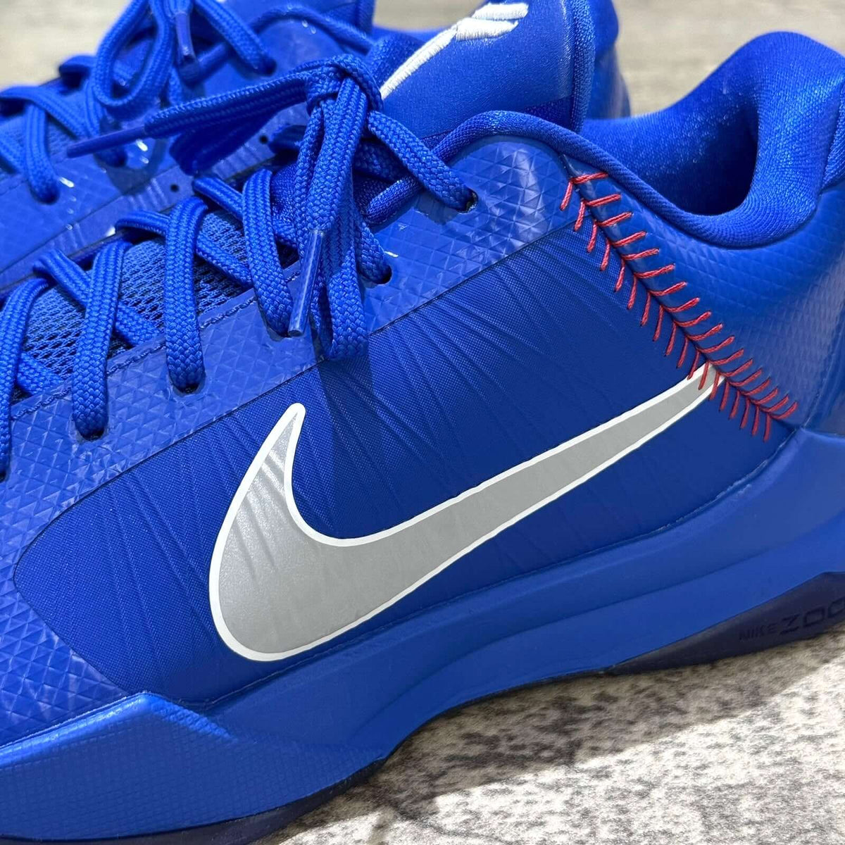 Nike Zoom Kobe 5 Protro Dodgers IO6256-400 close-up of blue upper with silver Nike logo and red stitching details