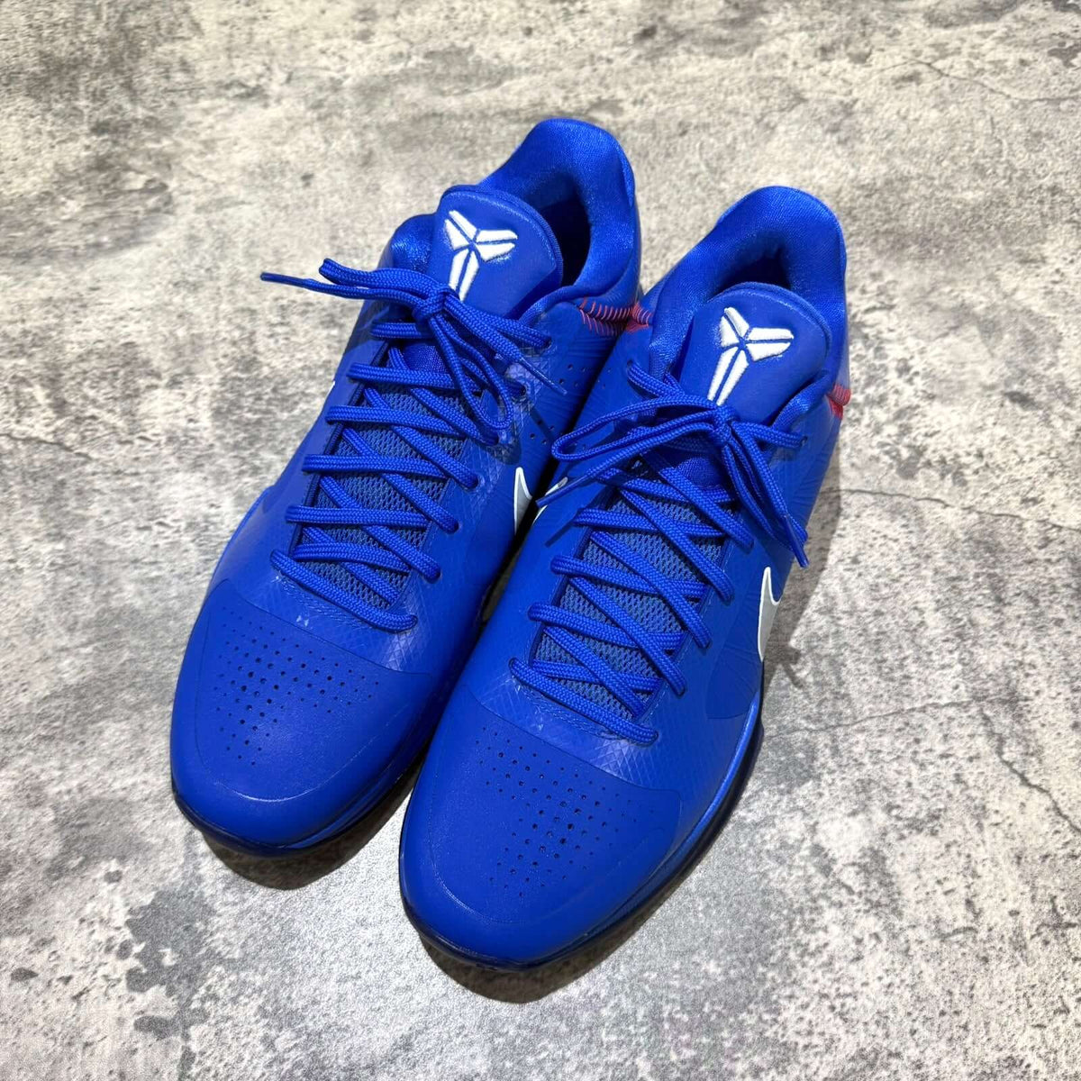 Nike Zoom Kobe 5 Protro Dodgers IO6256-400 shoes in vibrant blue with distinctive Kobe logo and sleek design.