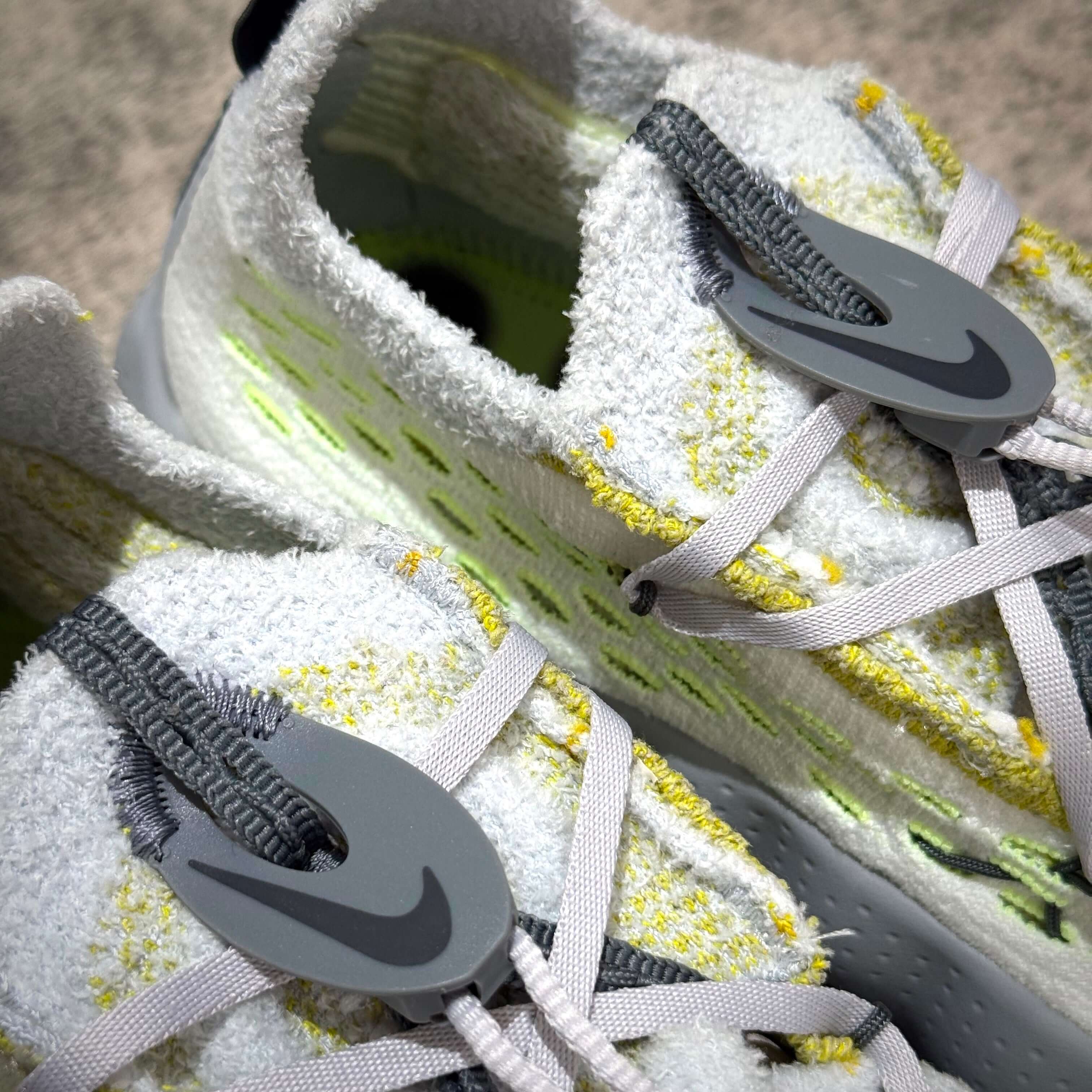 Nike Mind 002 Flyknit - Wolf Grey close-up showcasing details of the shoe's design and lacing system.