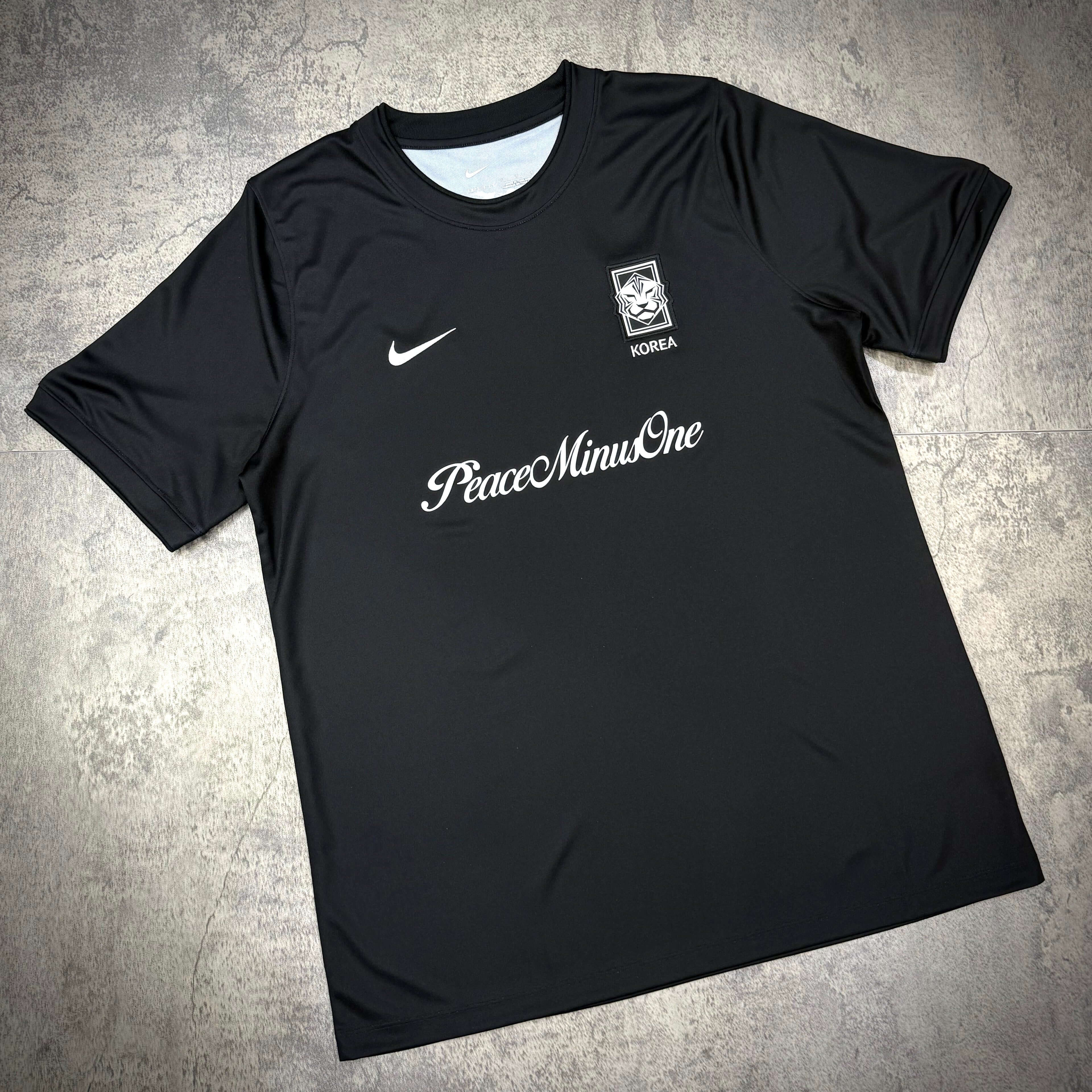 Nike x Peaceminusone x Korea KFA Academy Pro Football Top featuring PeaceminusOne logo on a black jersey.