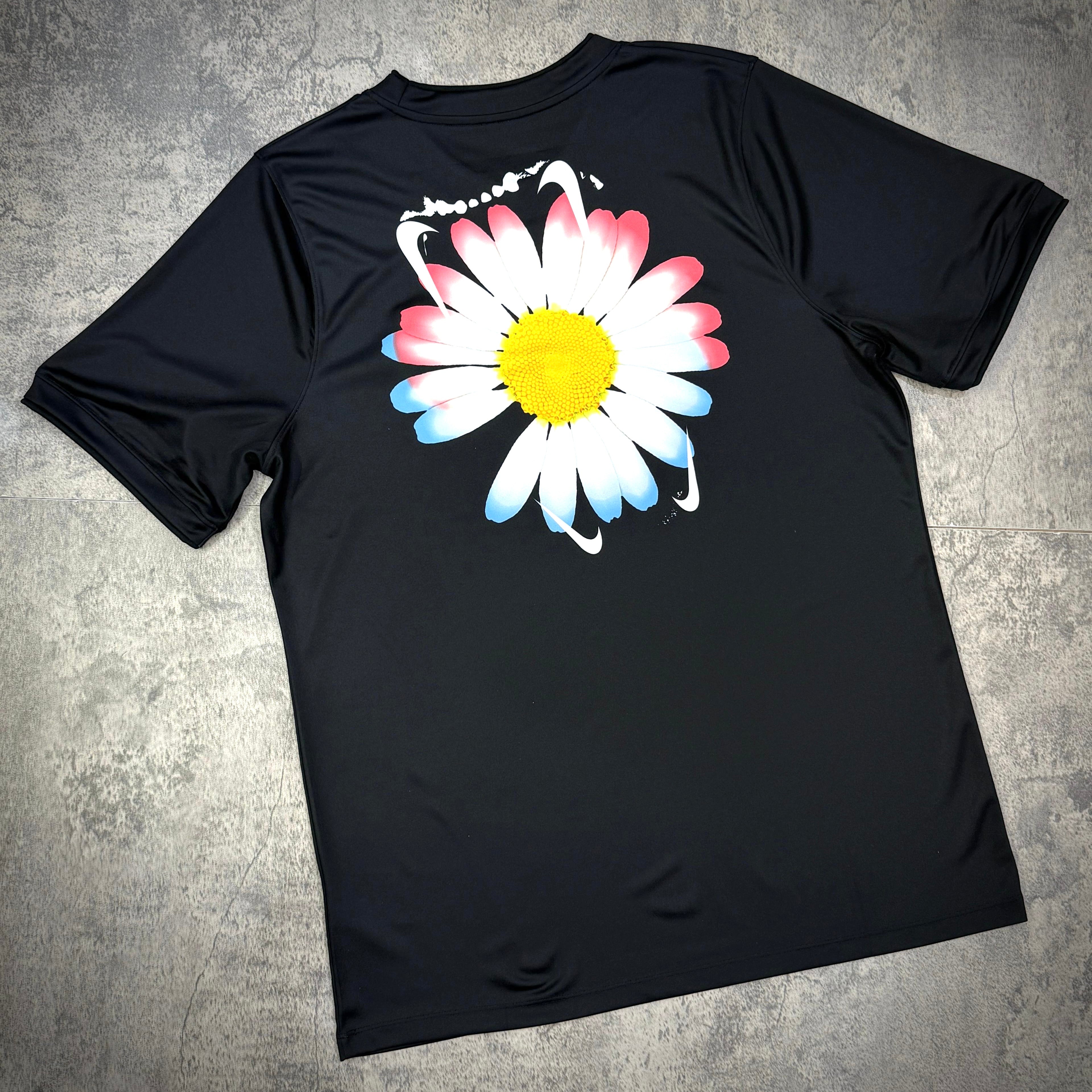 Black football top featuring a colorful daisy graphic on the back, part of the Nike x Peaceminusone x Korea KFA Academy collection.