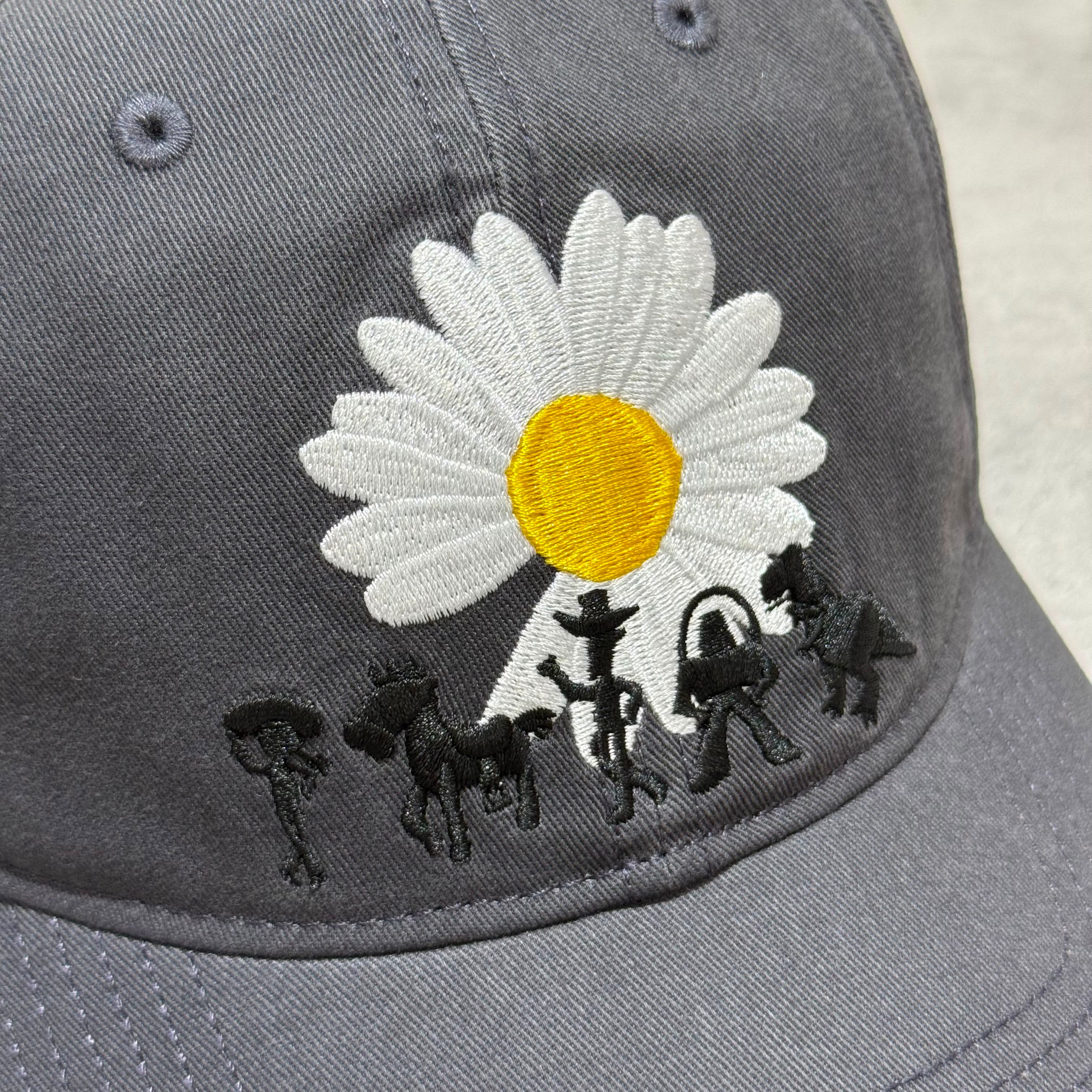 PEACEMINUSONE x Toy Story cap featuring embroidered flower and characters from Toy Story.