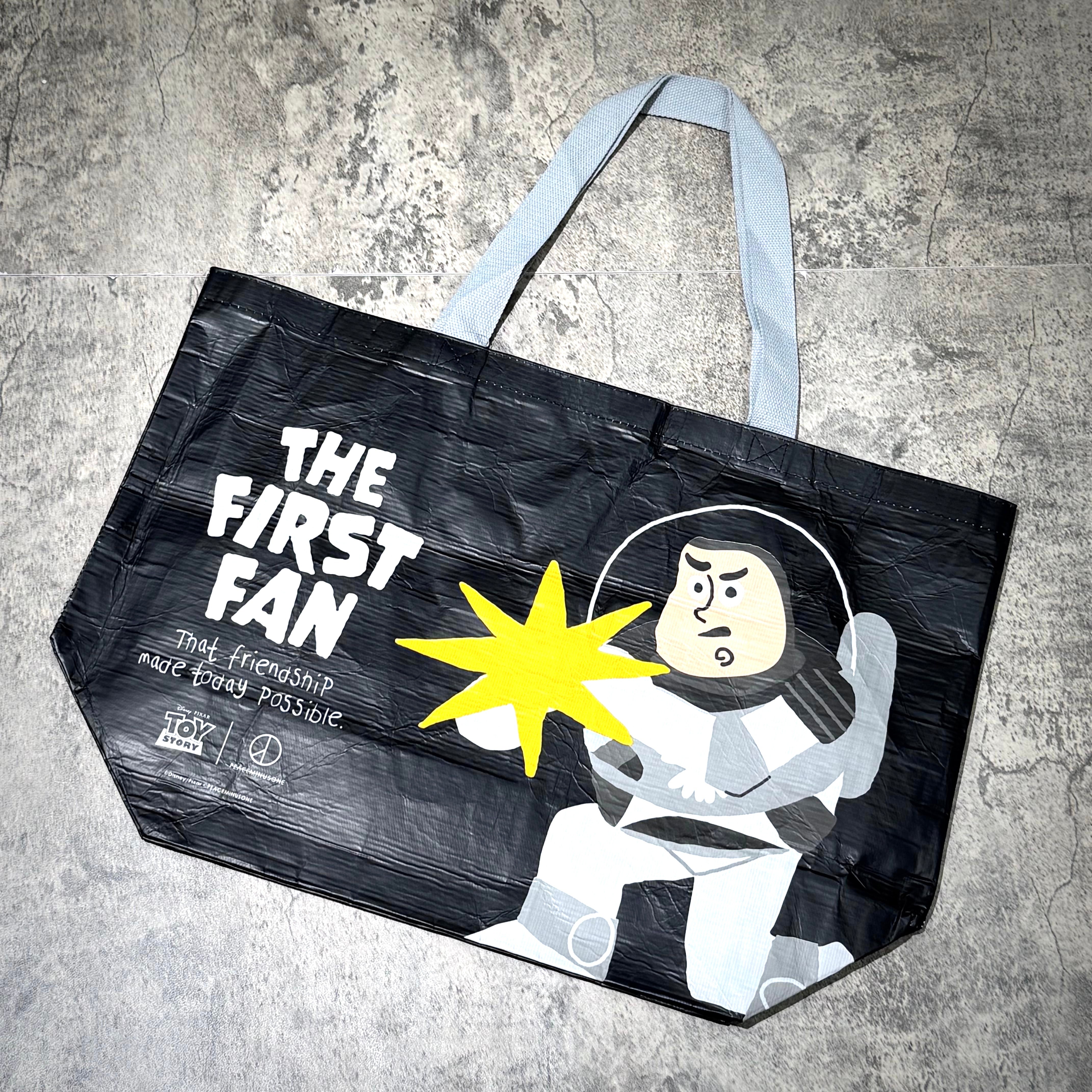 PEACEMINUSONE x Toy Story reusable bag featuring Buzz Lightyear with the text 'THE FIRST FAN'