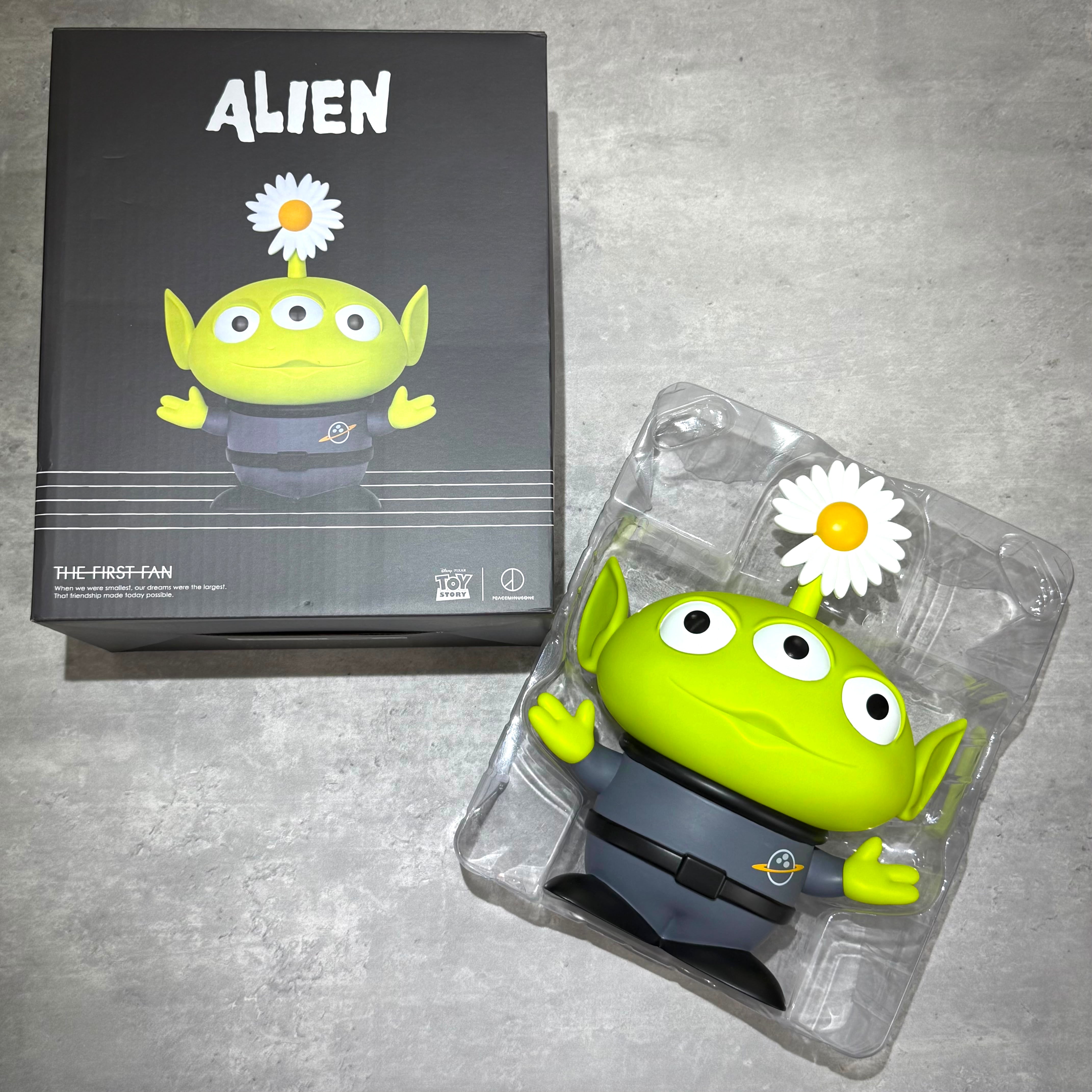 PEACEMINUSONE x Toy Story The First Fan - Collectable Toy Alien displayed in packaging with daisy flower detail.