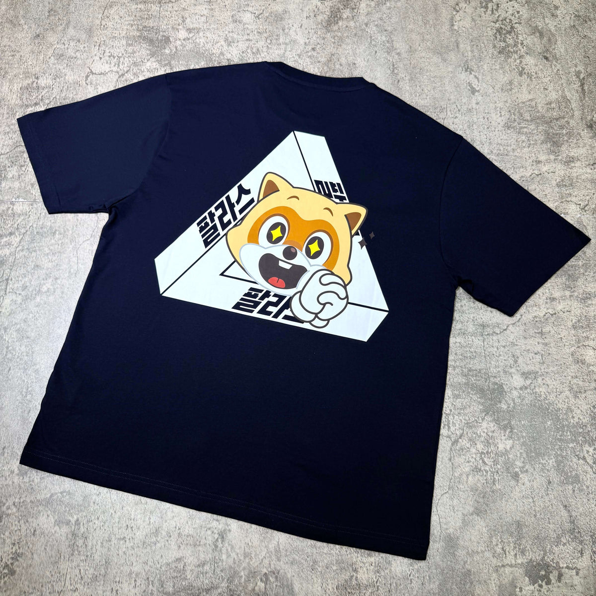 Palace Jamsil Exclusive Lotte Tri-ferg Tee with cartoon character graphic on navy background.