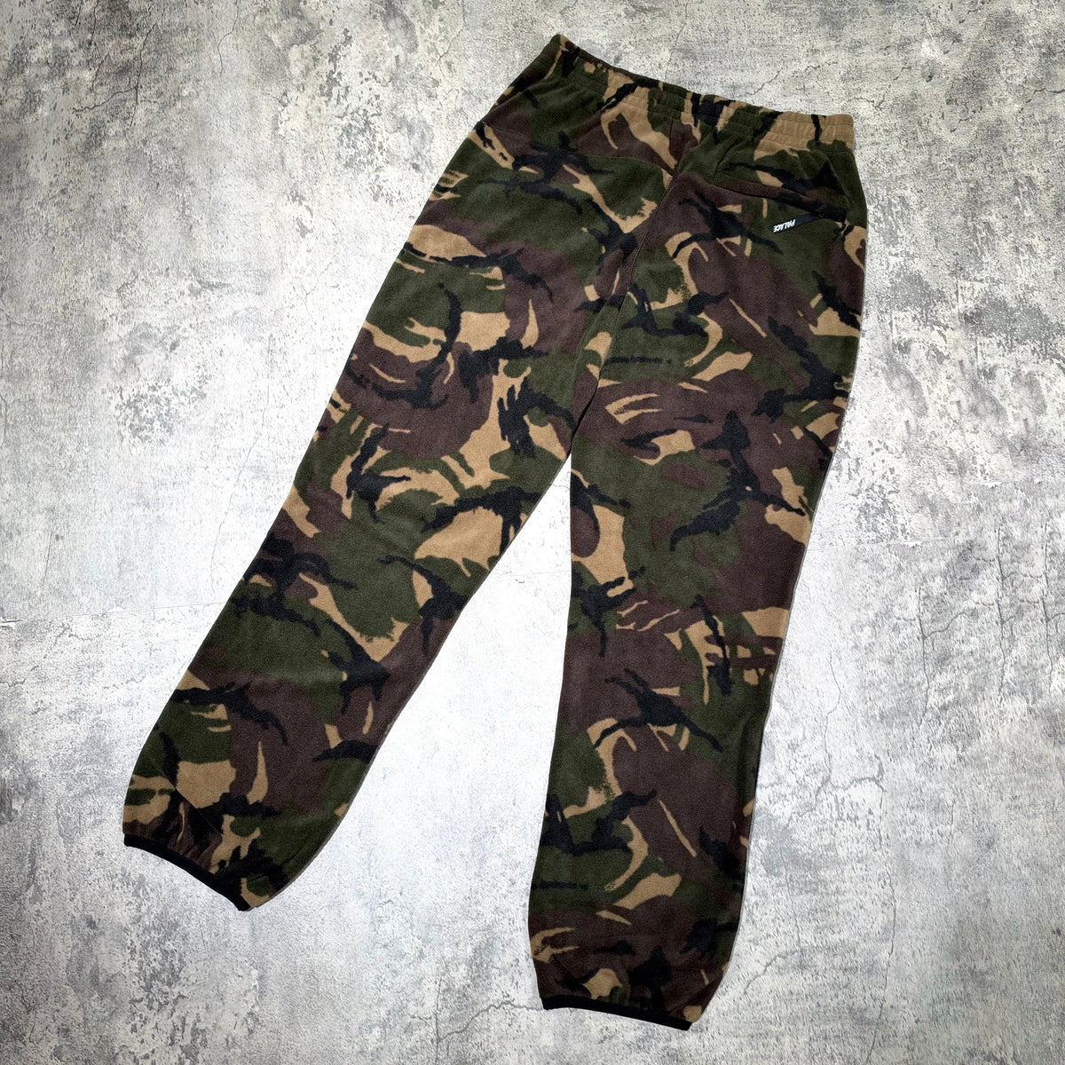 Palace P-Surgent Fleece Joggers Black DPM in a camo pattern on a textured background