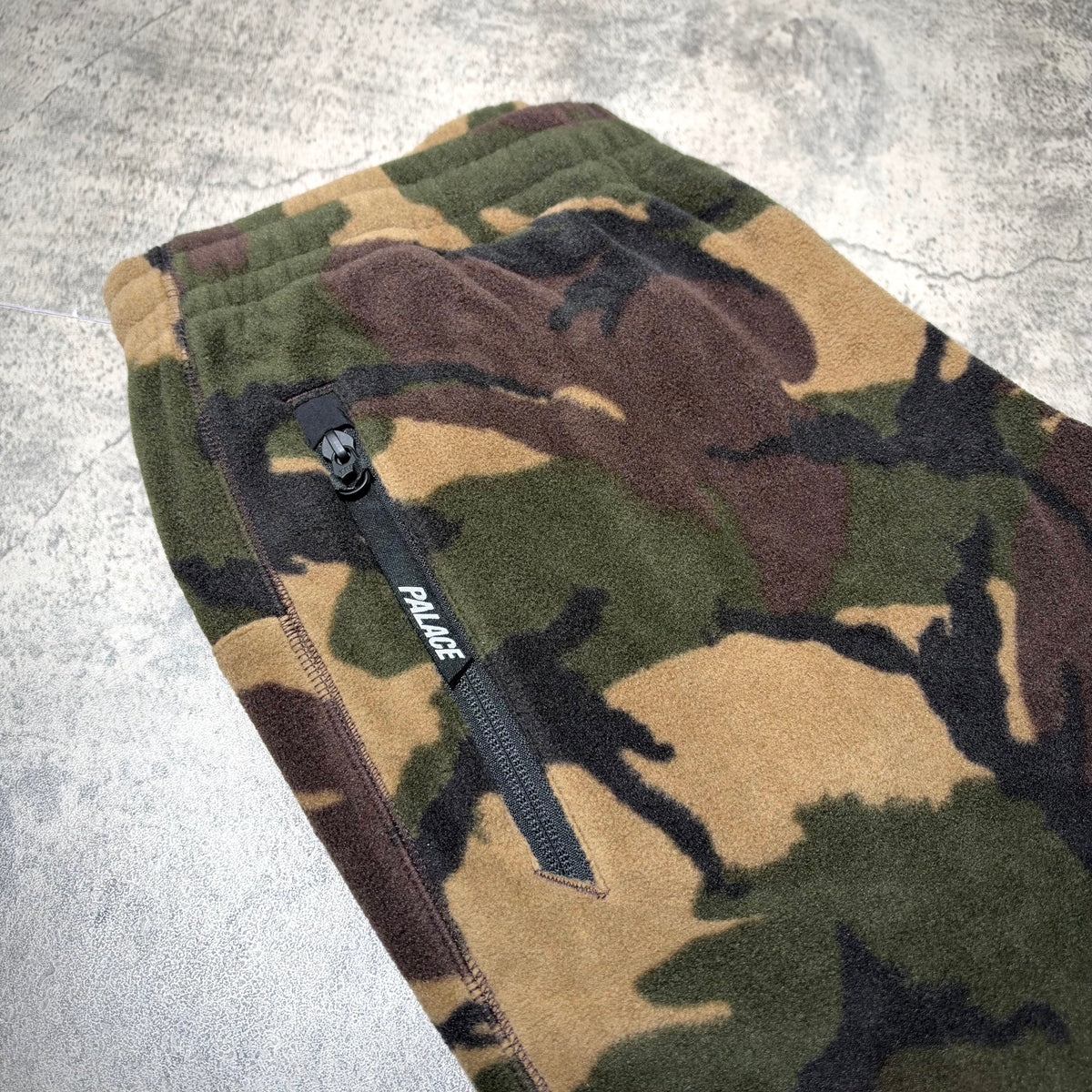 Close-up view of Palace P-Surgent Fleece Joggers Black DPM showcasing the camouflage pattern and zip pocket.
