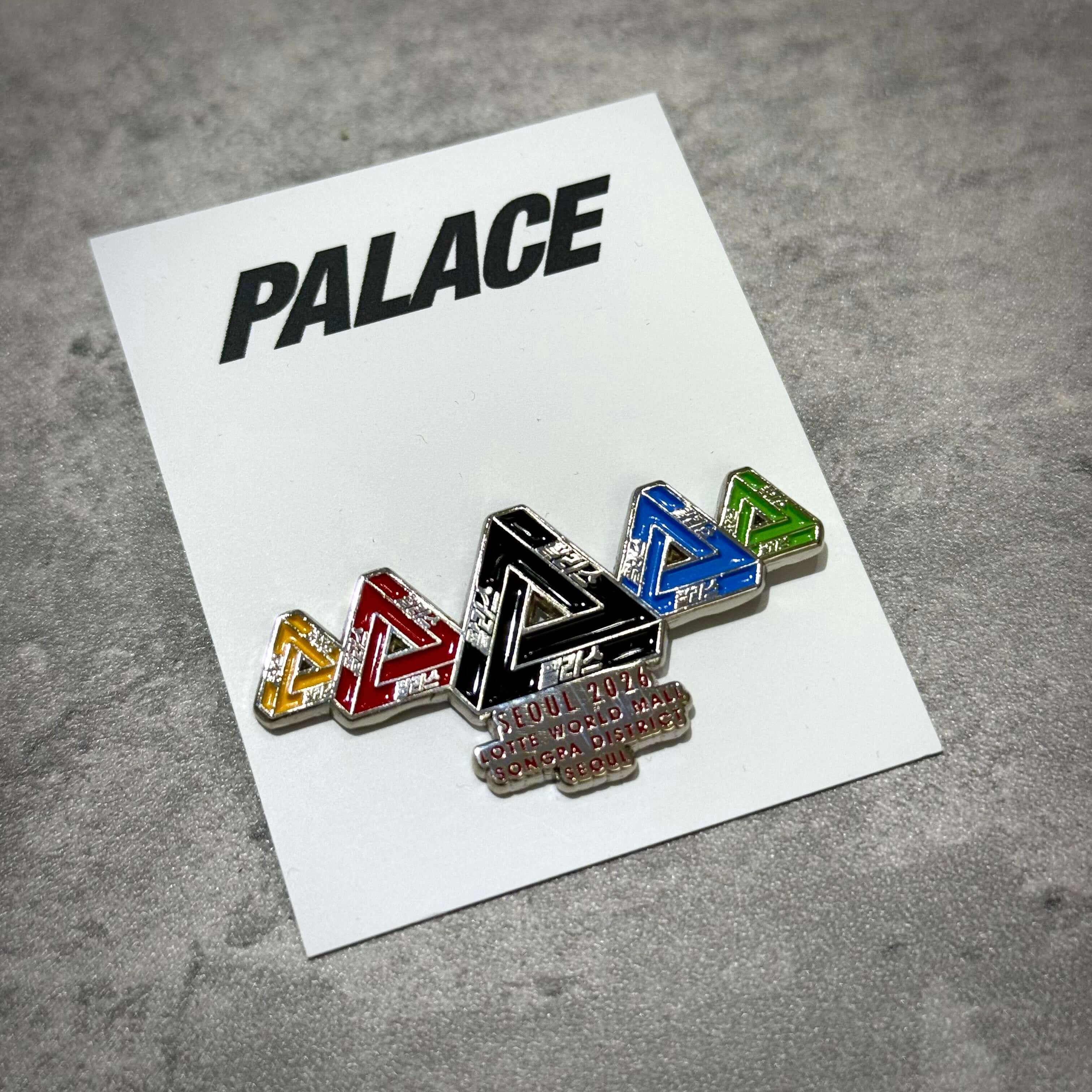 Palace Jamsil Exclusive Accessories badge with colorful triangles on a white background.