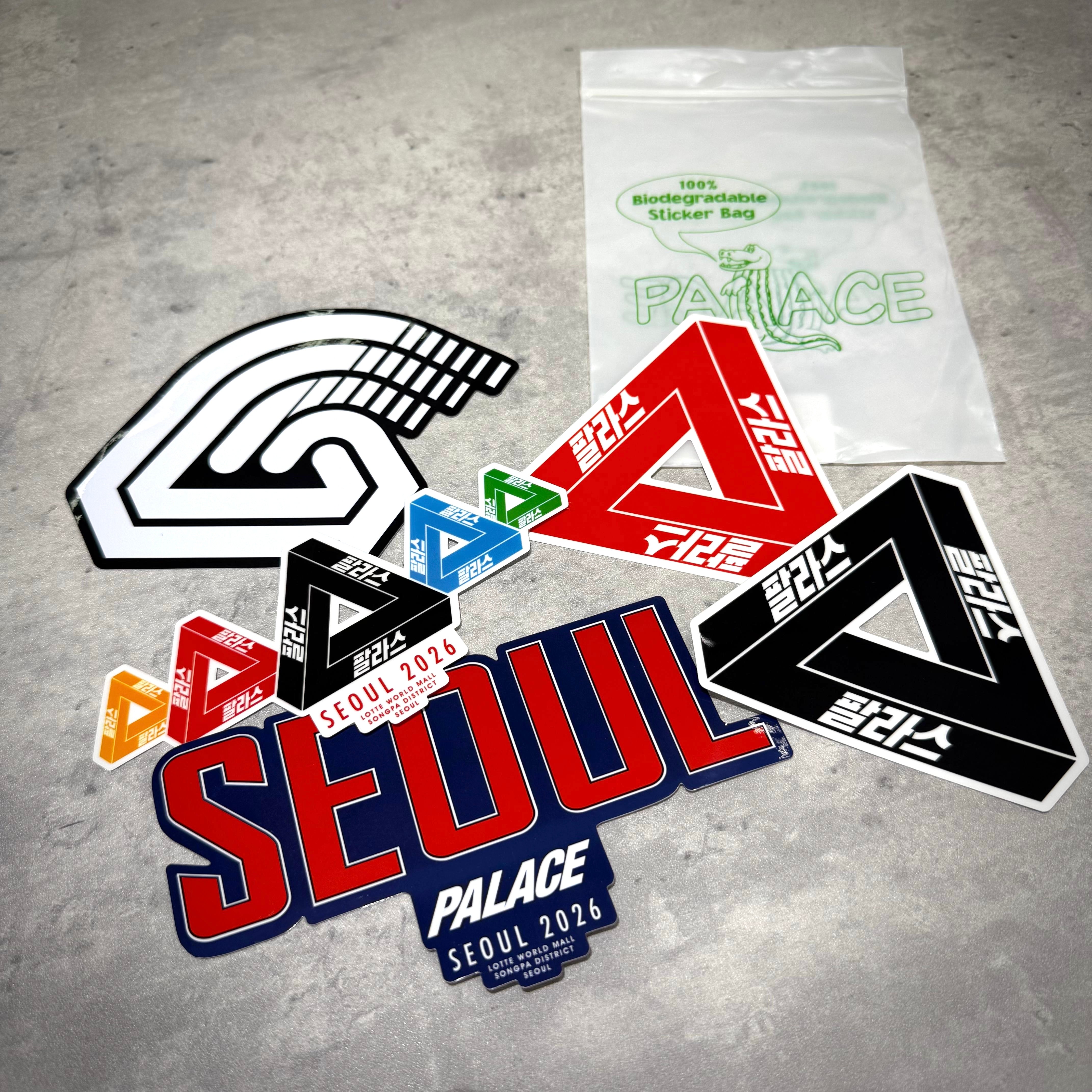 Palace Jamsil Exclusive Accessories featuring colorful stickers and biodegradable packaging on a surface.