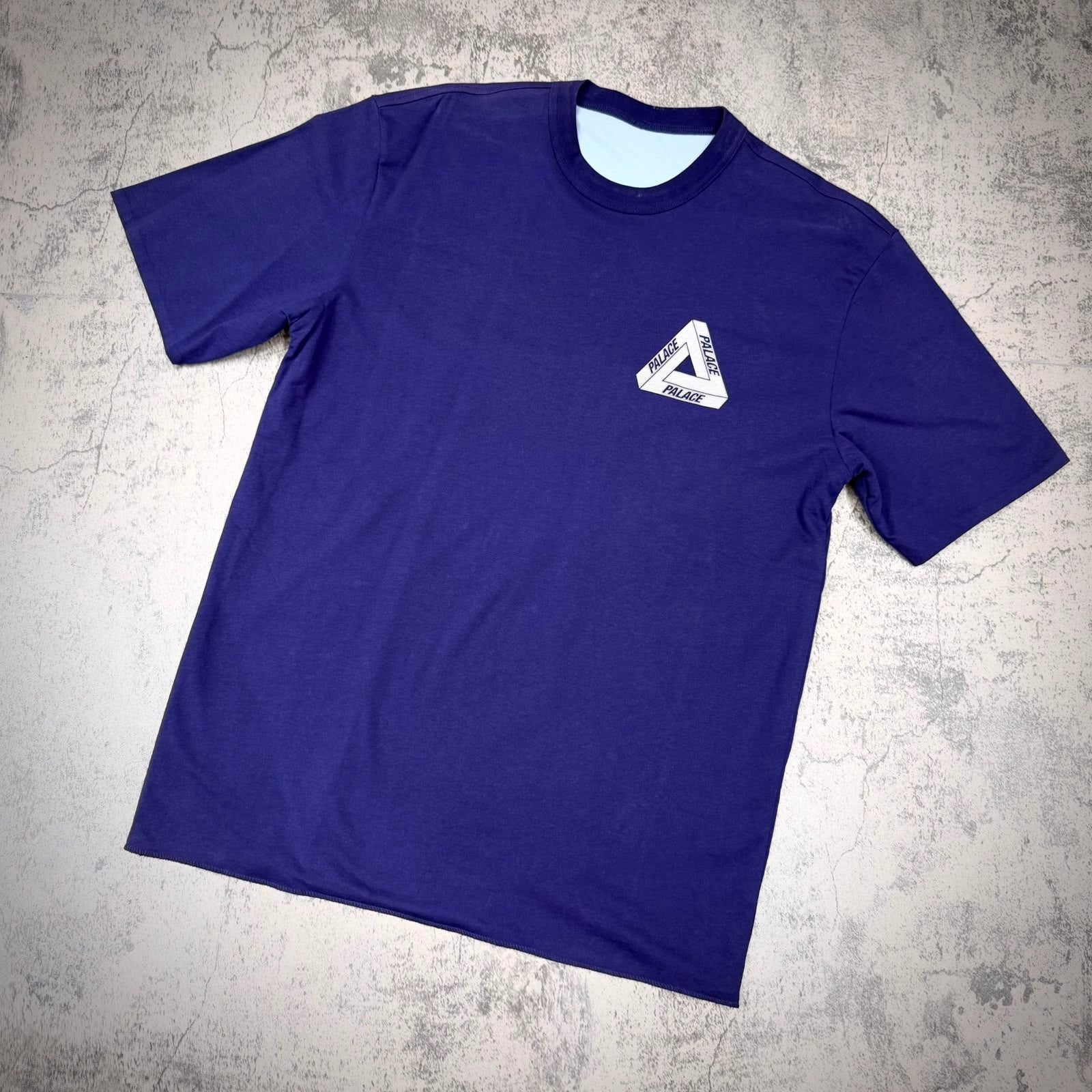 Palace Reverso Tee - Navy sky displayed on a grey background, showcasing its front design and color.