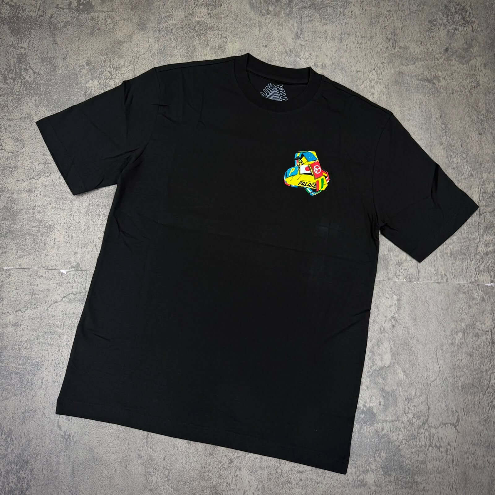 Palace Tri-Flag Tee - Black featuring a vibrant graphic design on the chest.