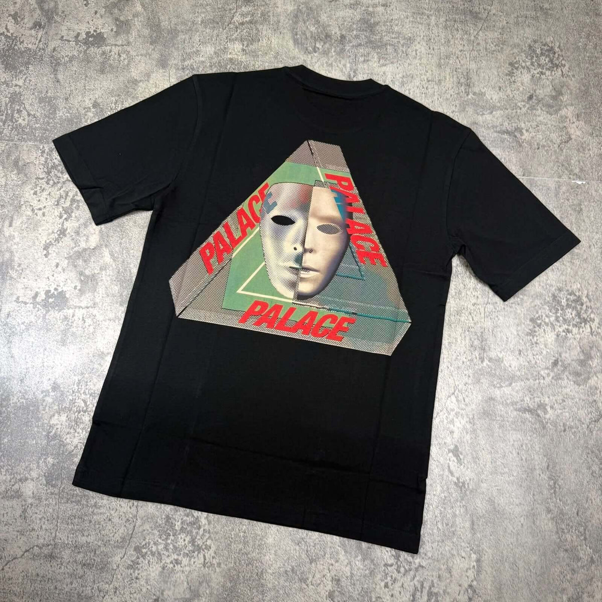 Palace Tri-Bury Tee - Black with unique graphic design featuring a mask and pyramid logo.