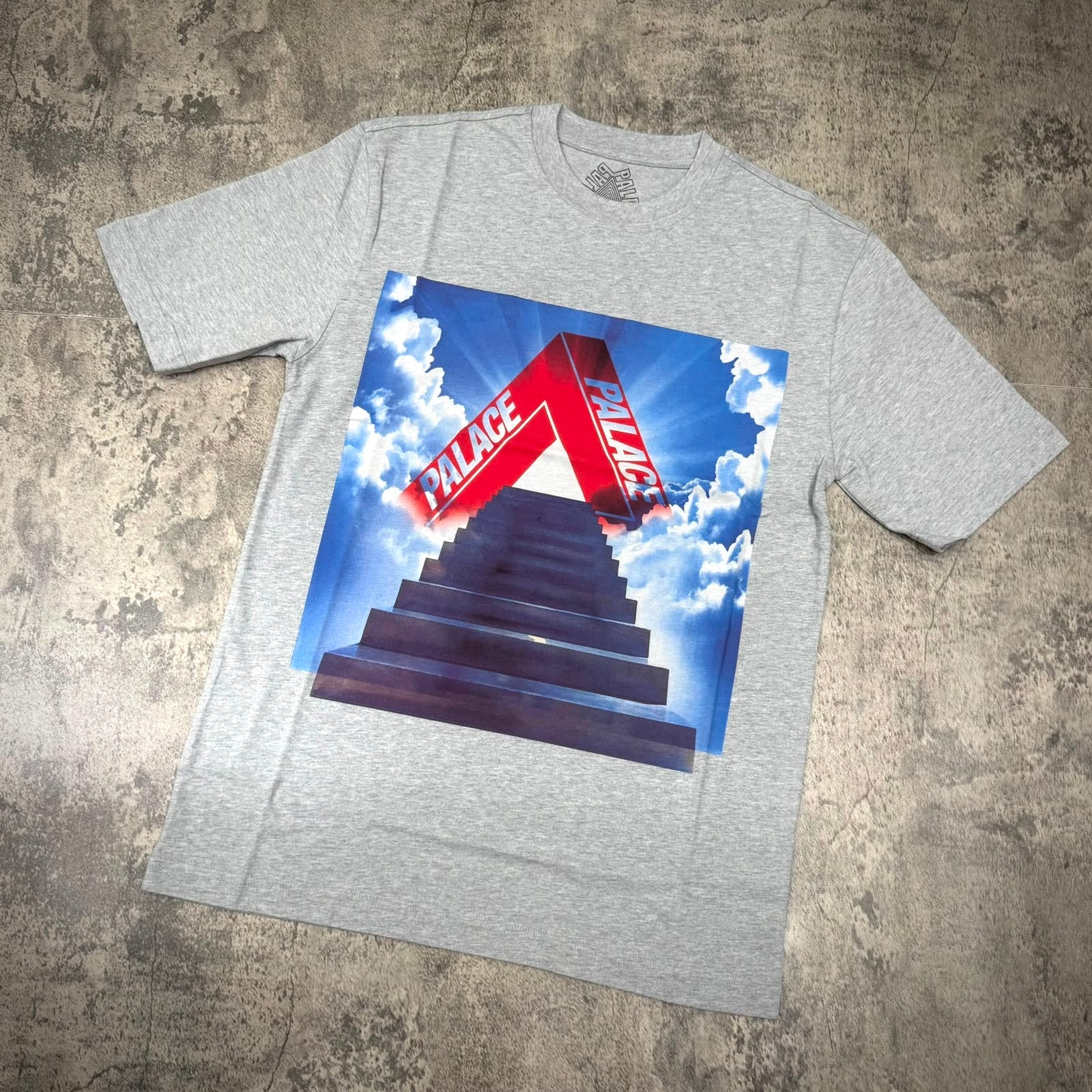 Palace Tri-Ternity Tee - Grey with bold graphic design featuring the Palace logo and a staircase leading to clouds.