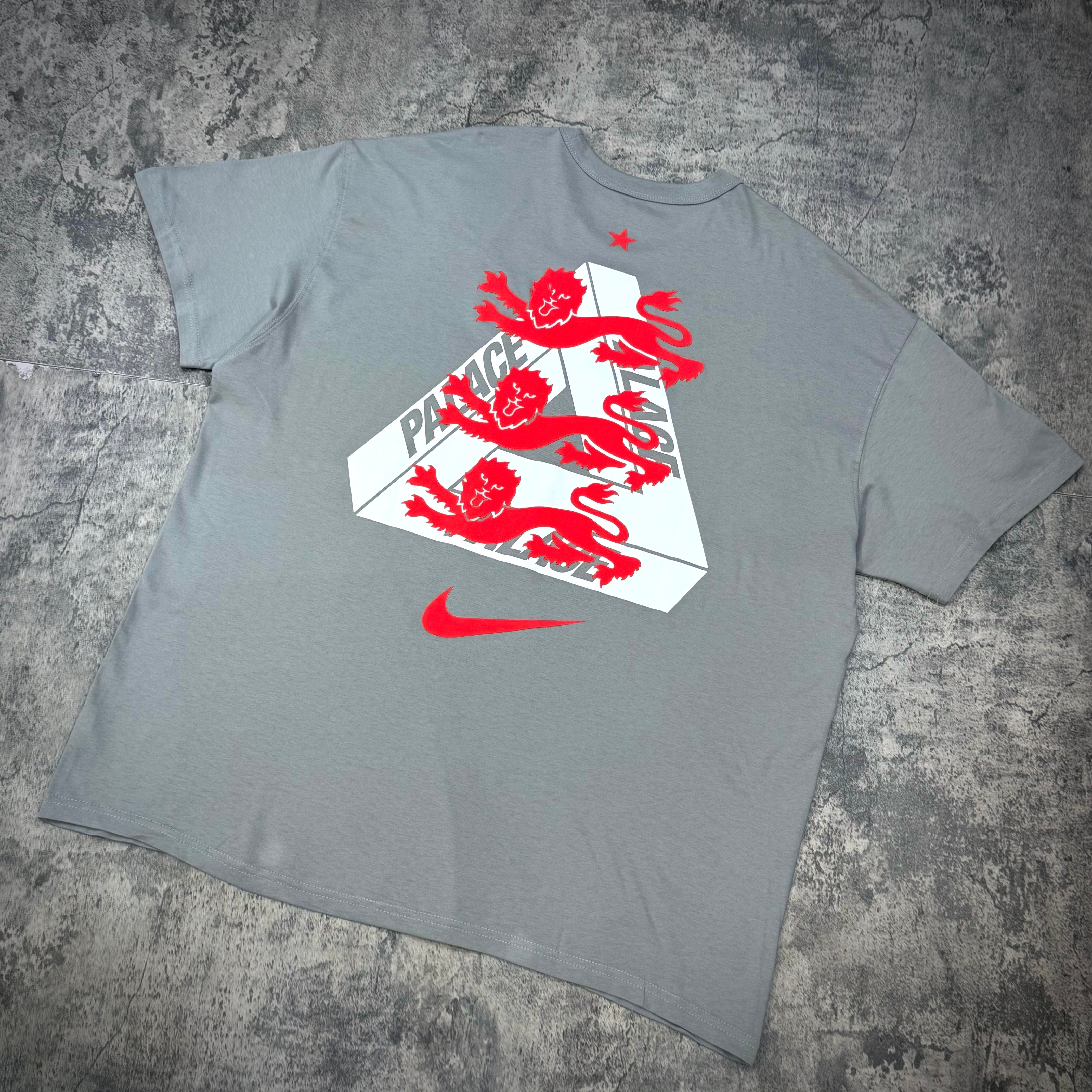 Palace x Nike England Tee showcasing a grey shirt with red lion graphics and logo design on the back.