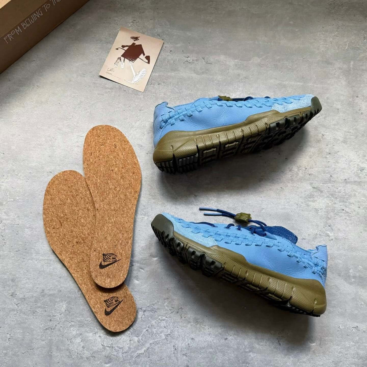 SOULGOODS x Nike Homescape Woven Blue Beyond HM6961-400 displayed with insoles on a grey surface.