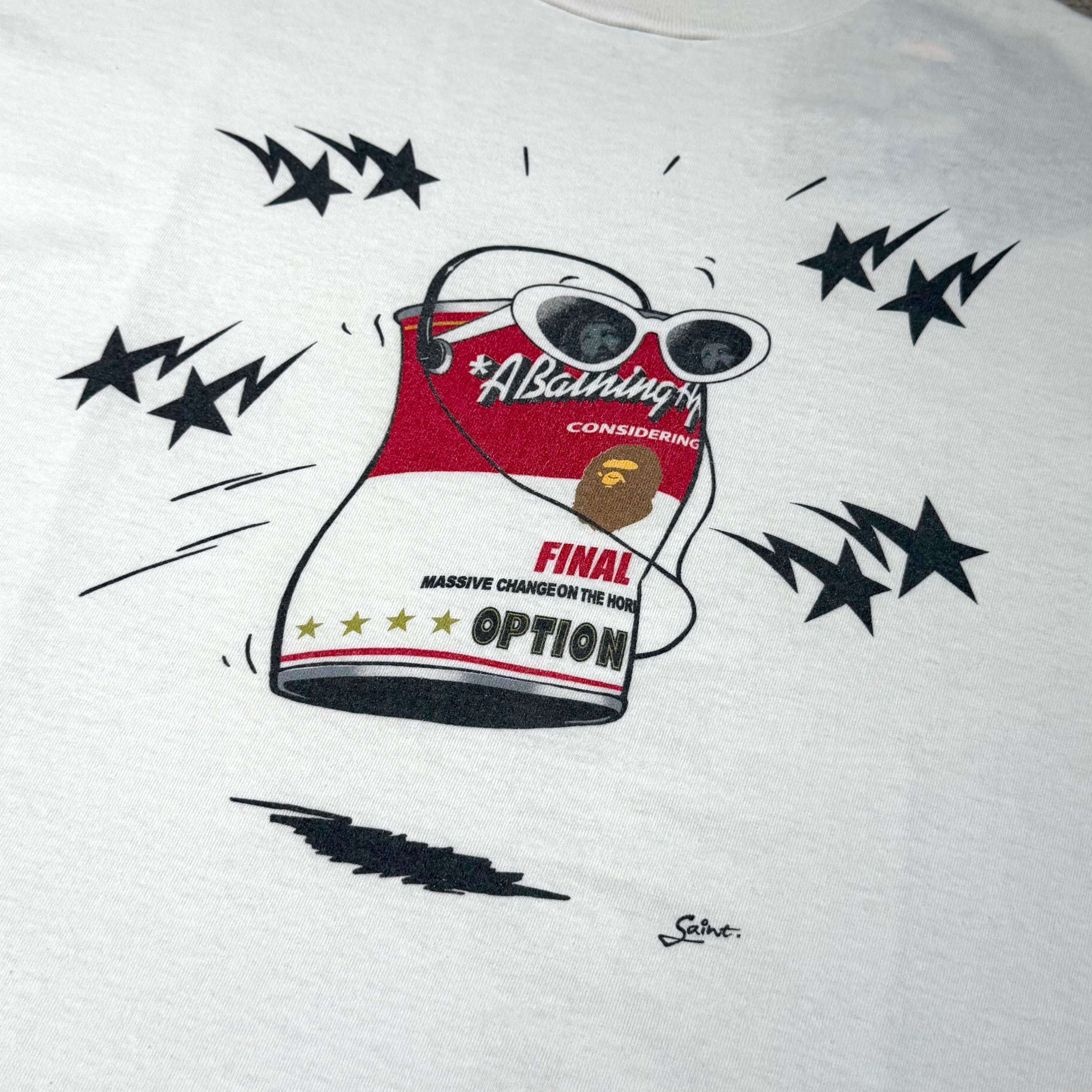 Saint Mxxxxxx BAPE Jump Tee design featuring a cartoon can with sunglasses and dynamic star accents.