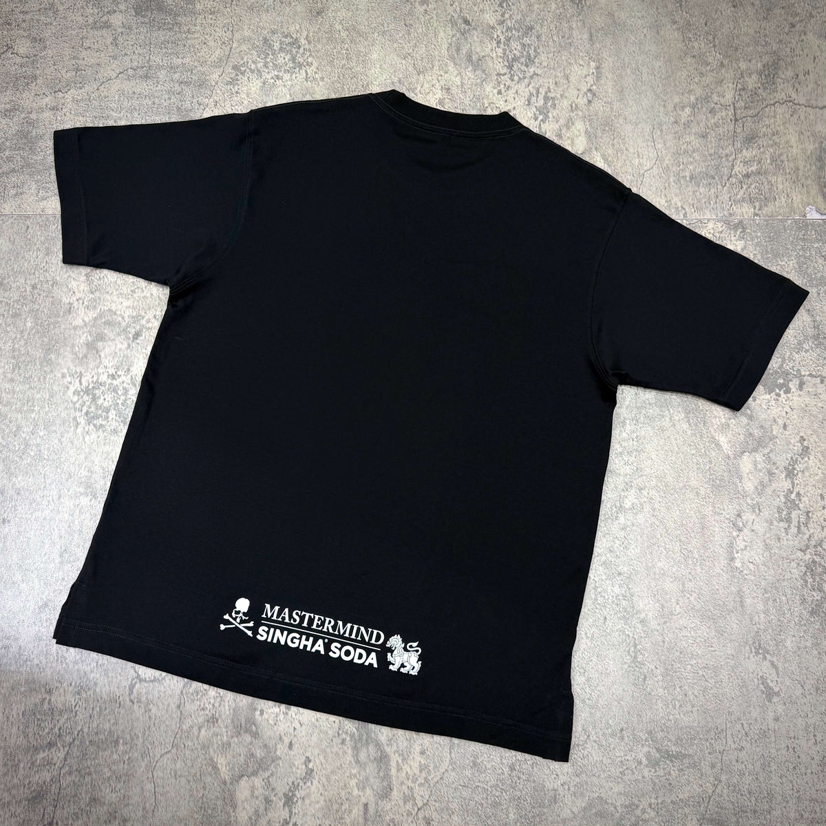 Singha Soda x Mastermind World SS Tee #2 black t-shirt featuring brand logo on the back.