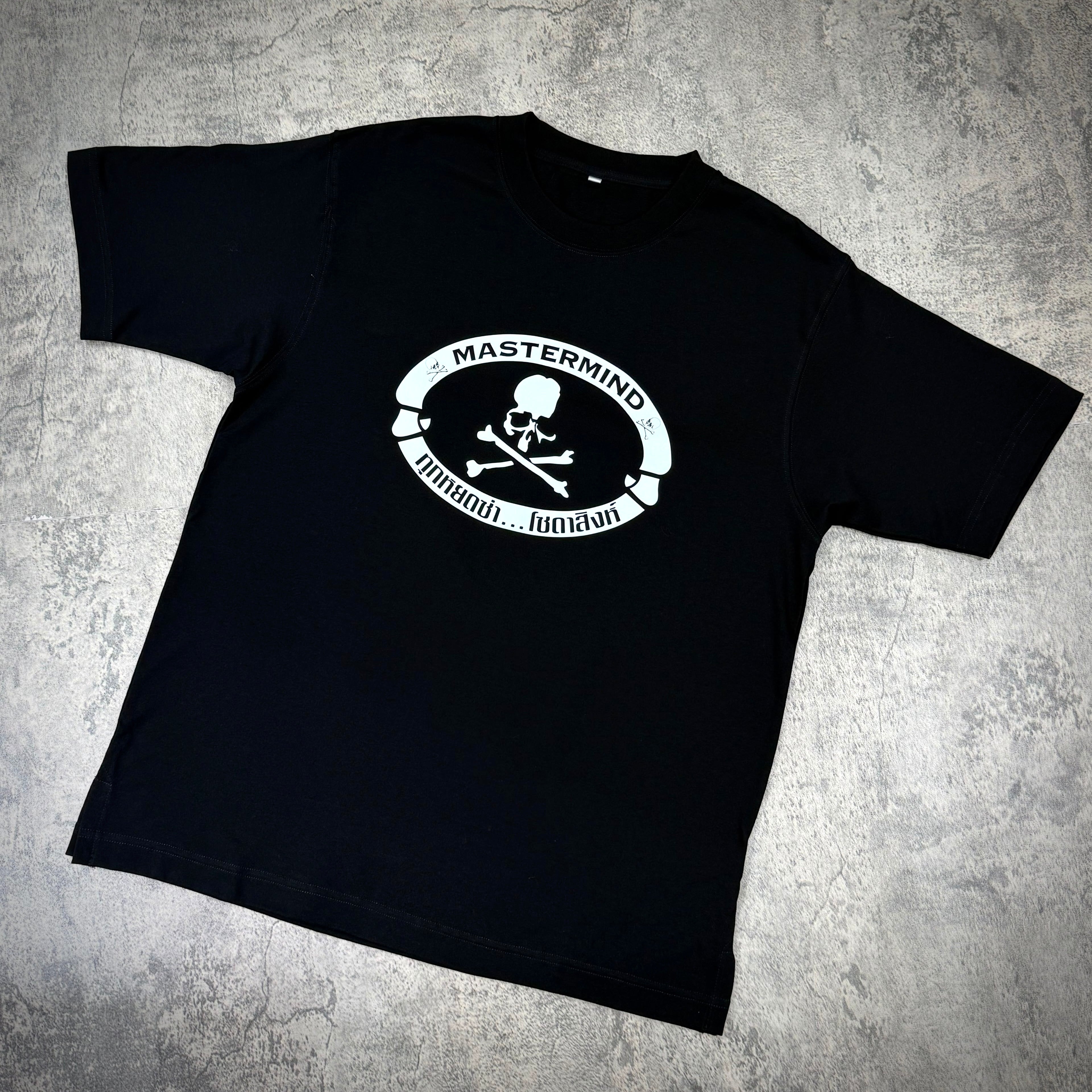 Singha Soda x Mastermind World SS Tee #1 featuring a black t-shirt with a Mastermind logo and skull design.