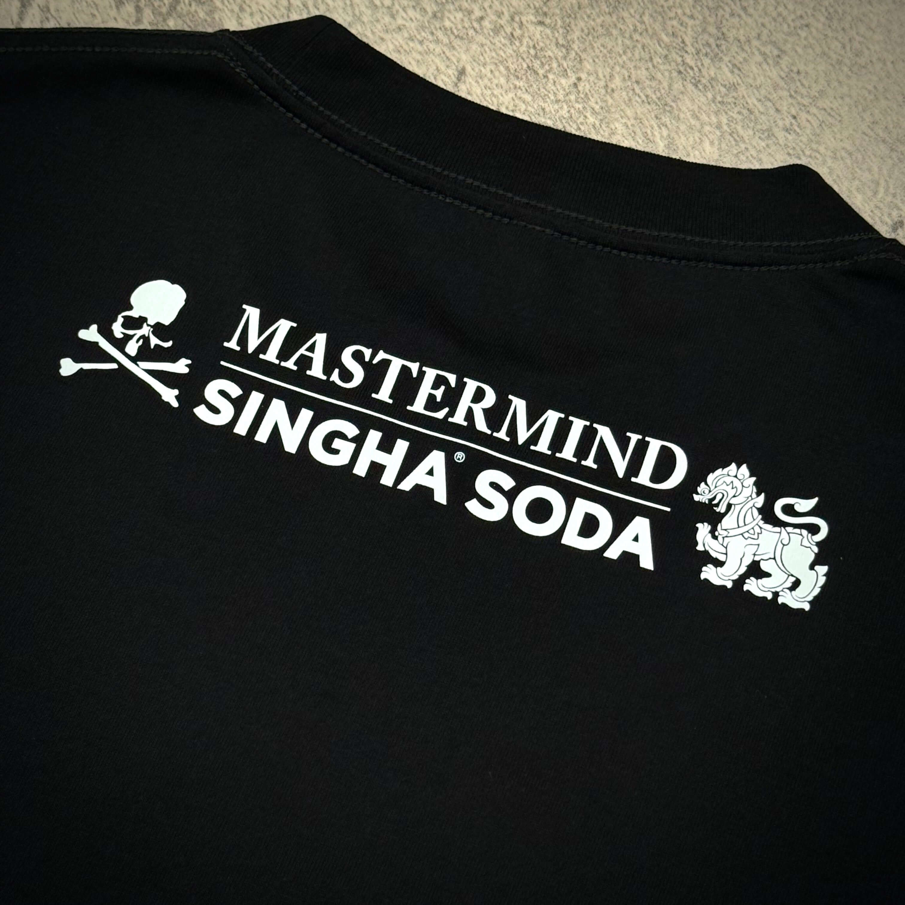 Back view of Singha Soda x Mastermind World SS Tee #1 featuring logo and design elements.