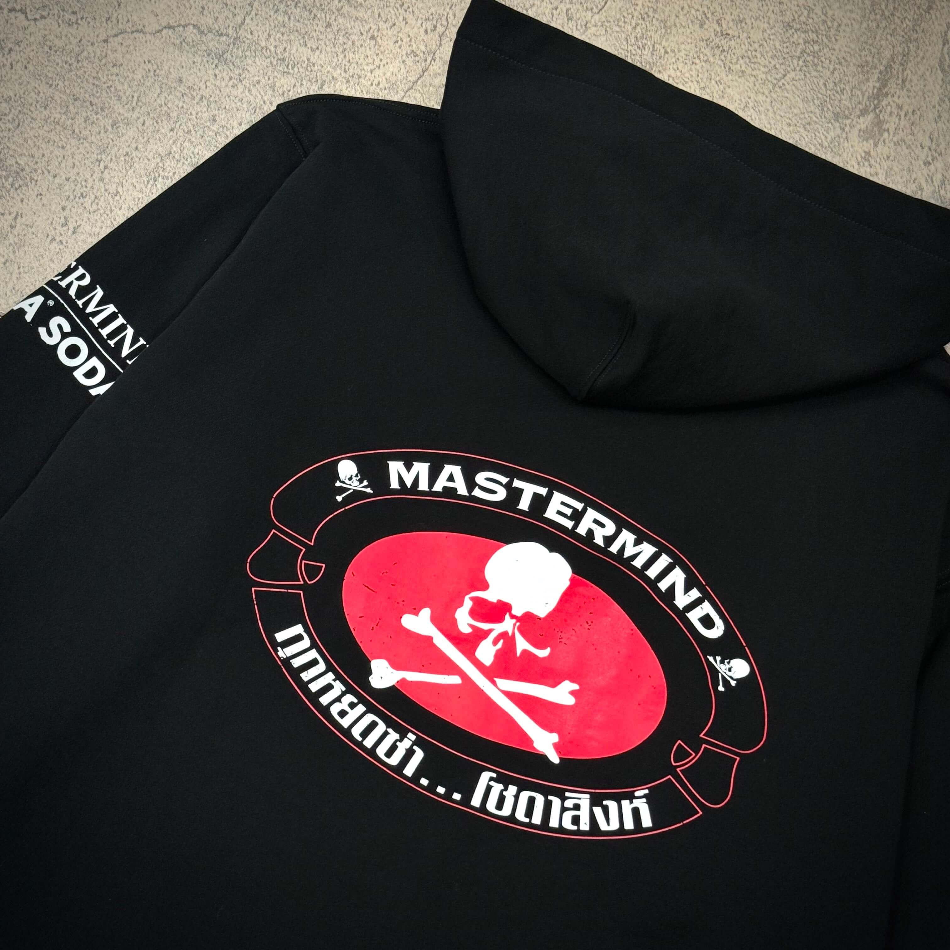 Back view of Singha Soda x Mastermind World Zip Up Hoodie featuring the signature skull and crossbones design.