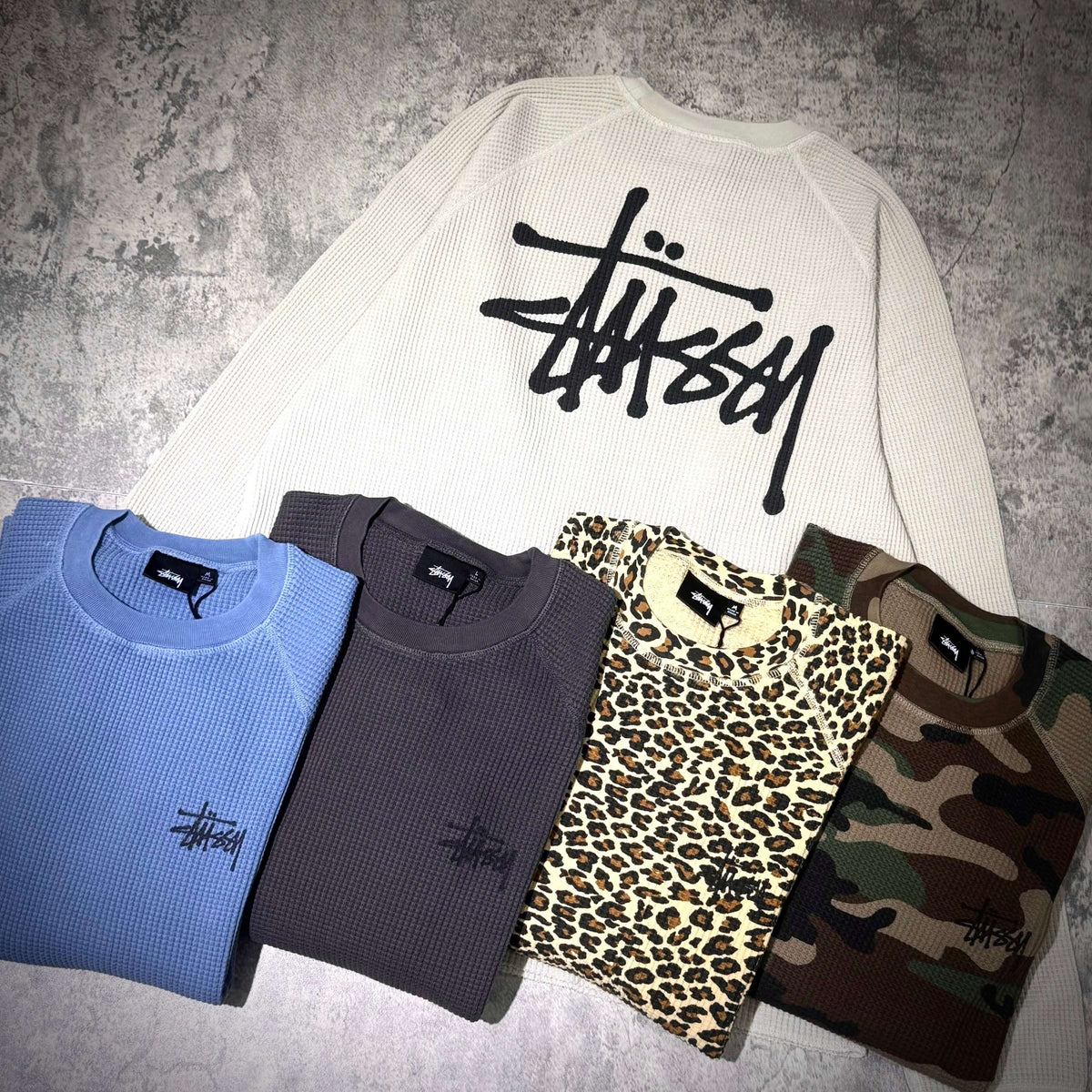 Stussy Basic Raglan Thermal LS Crew FW26 in multiple colors including blue, gray, leopard print, and camo styles.