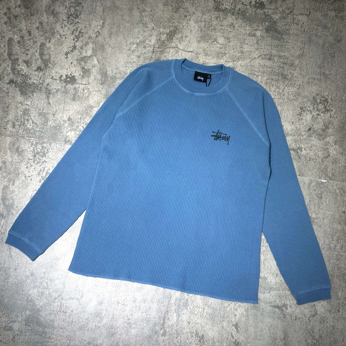 Stussy Basic Raglan Thermal LS Crew FW26 in blue, featuring a classic ribbed texture and logo.