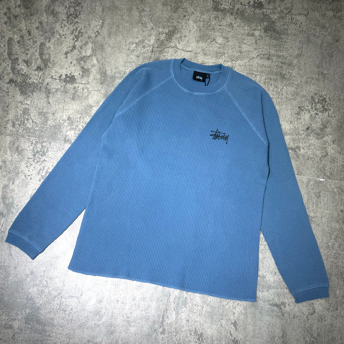 Stussy Basic Raglan Thermal LS Crew FW26 in blue, featuring a classic ribbed texture and logo.