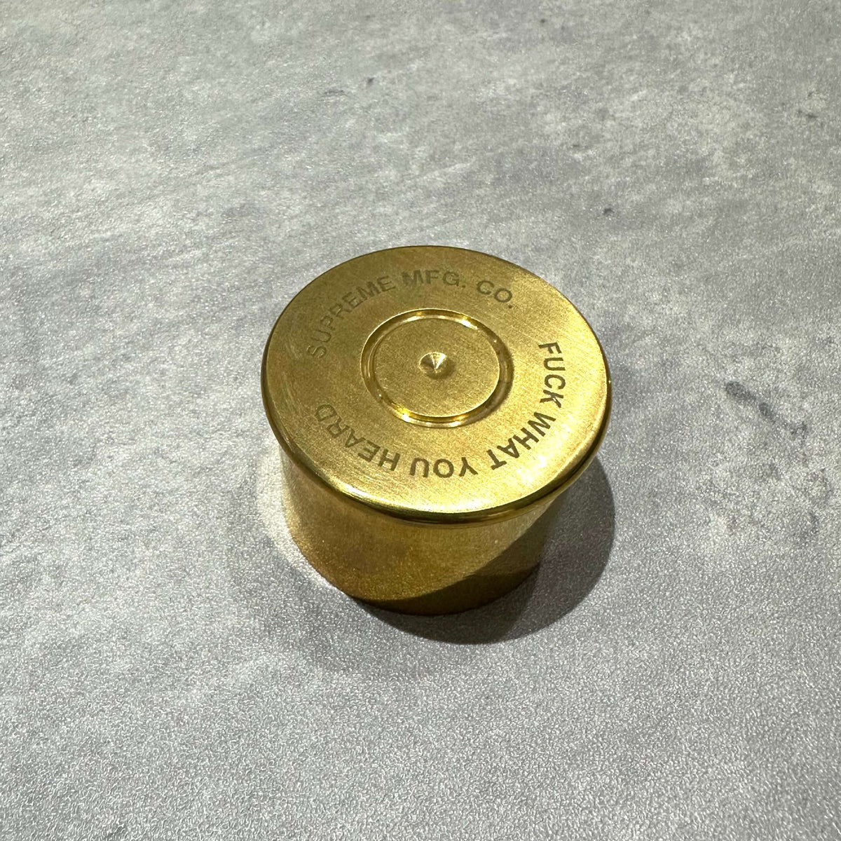 Supreme English Pewter Company Bullet Flask, gold finish, circular design with engraved text.