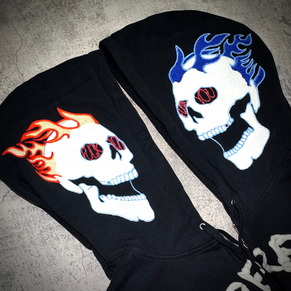 Supreme Fuck You Zip Up Hooded Sweatshirt featuring skull designs on the hood, black background, bold colors