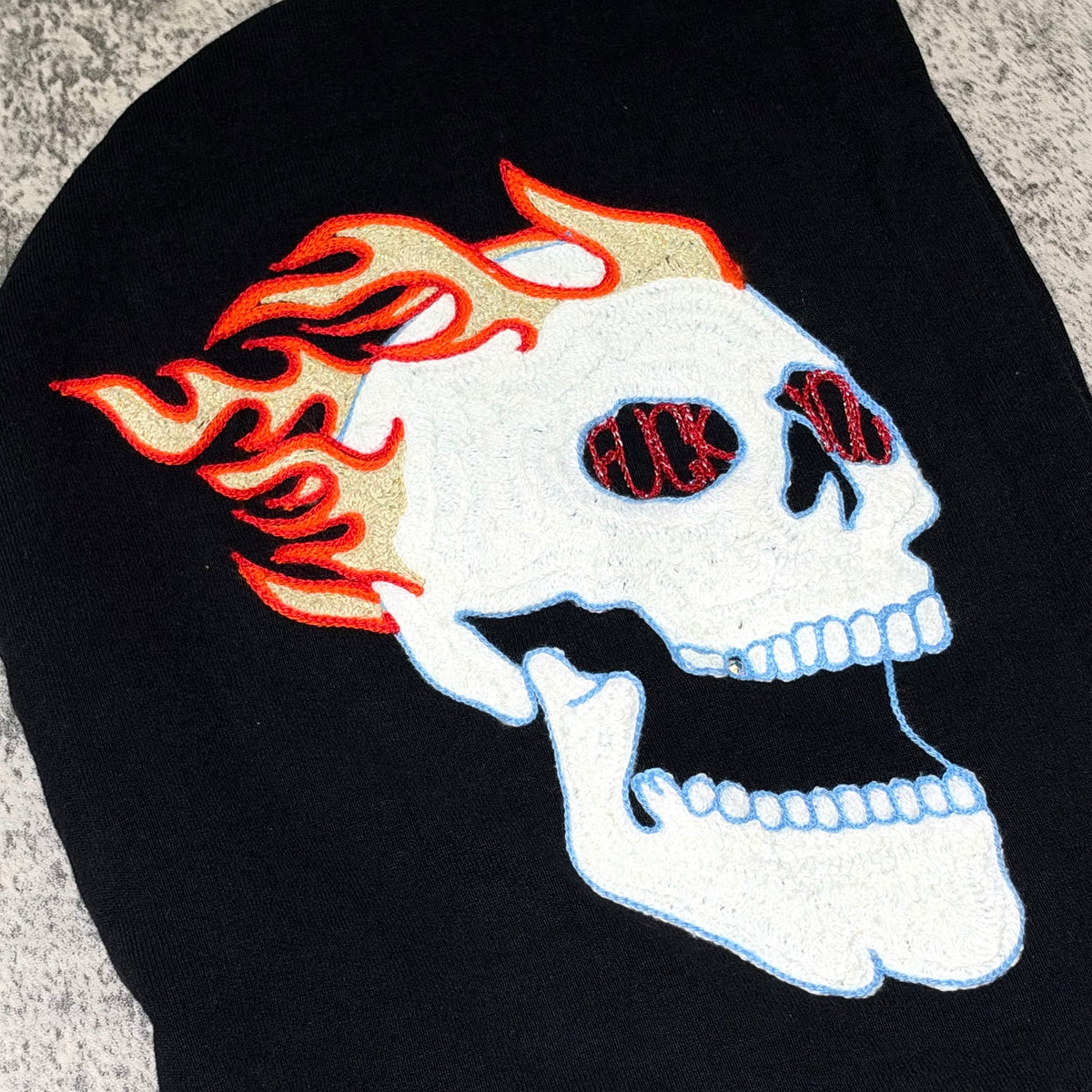 Supreme Fuck You Zip Up Hooded Sweatshirt black design featuring embroidered skull with flames.
