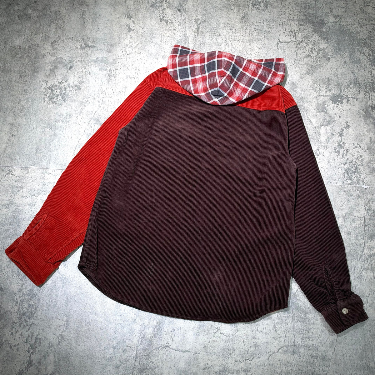 Supreme Hooded Color Blocked Corduroy Shirt displayed from the back with red and brown color blocking and plaid hood.