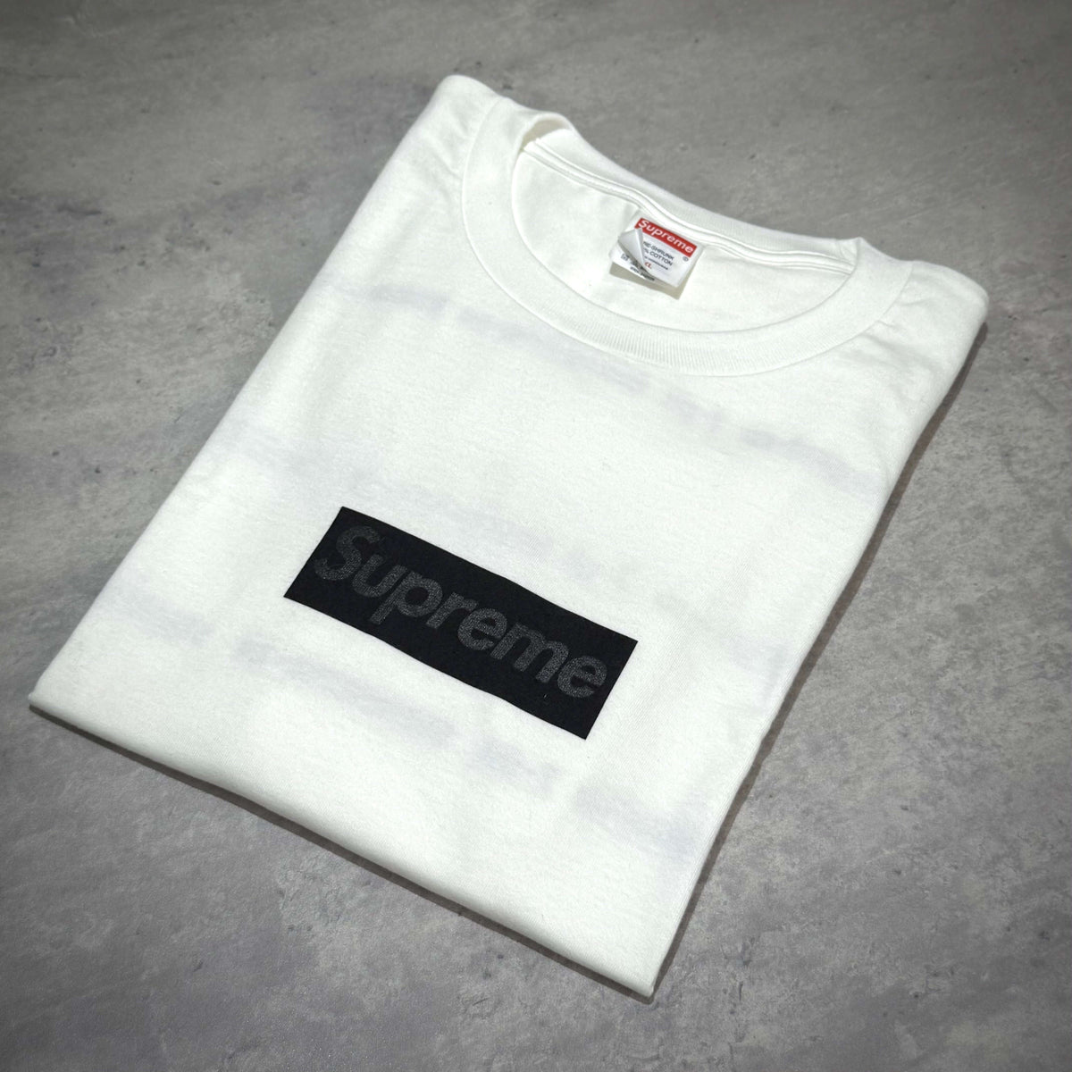 Supreme Seoul Box Logo Tee FW26 - White laid flat showing the black box logo on a white shirt.