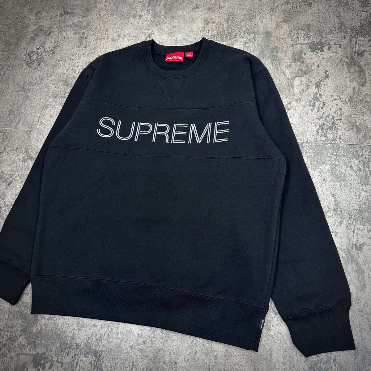 Supreme Zig Zag Stitch Panel Crewneck featuring a black design with embroidered text in white.