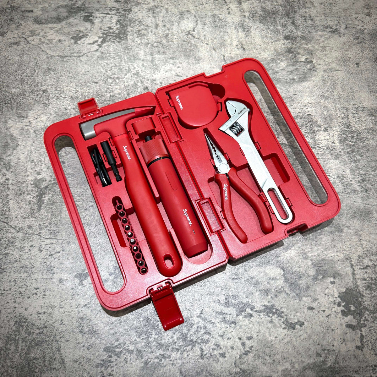 Supreme x Hoto 5-piece tool set in a durable red case with tools including a screwdriver, pliers, and wrench.