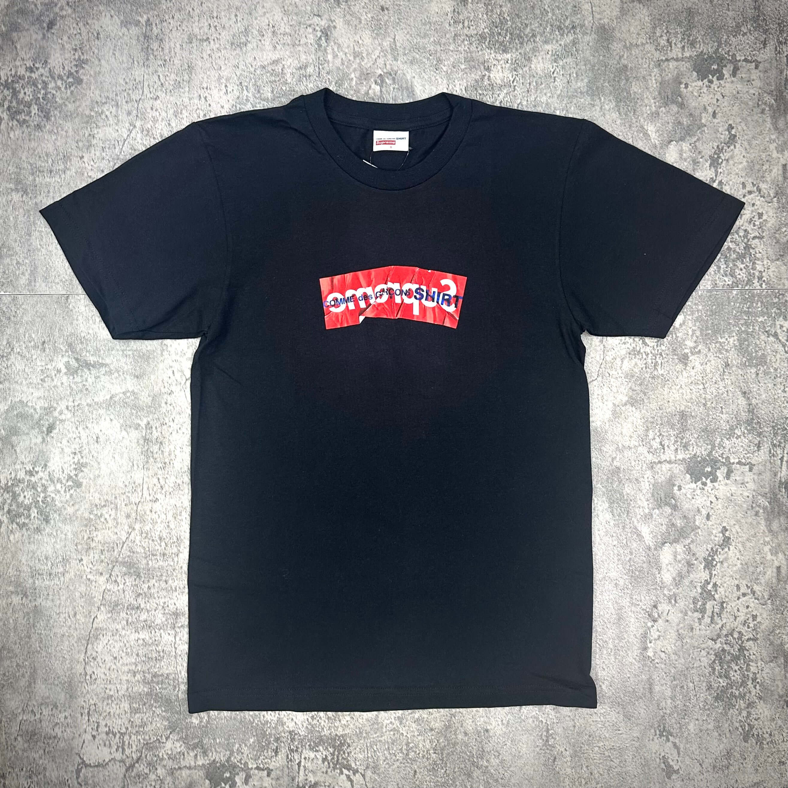 Supreme Comme Des Garcons SHIRT Box Logo Tee SS16 - Black with red and white graphic logo design on the front.