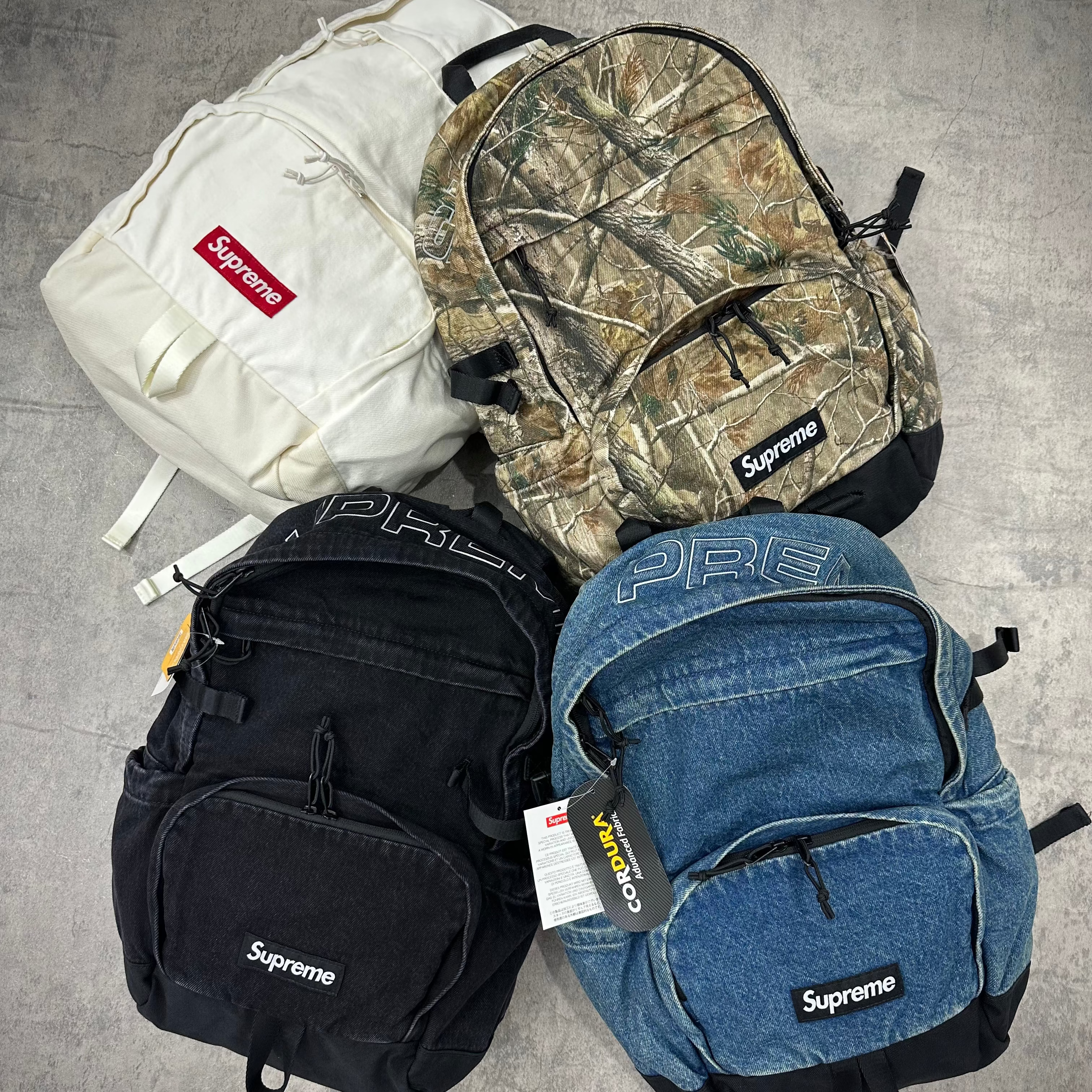 Supreme Denim Backpack FW25 washed indigo black realtree camo white