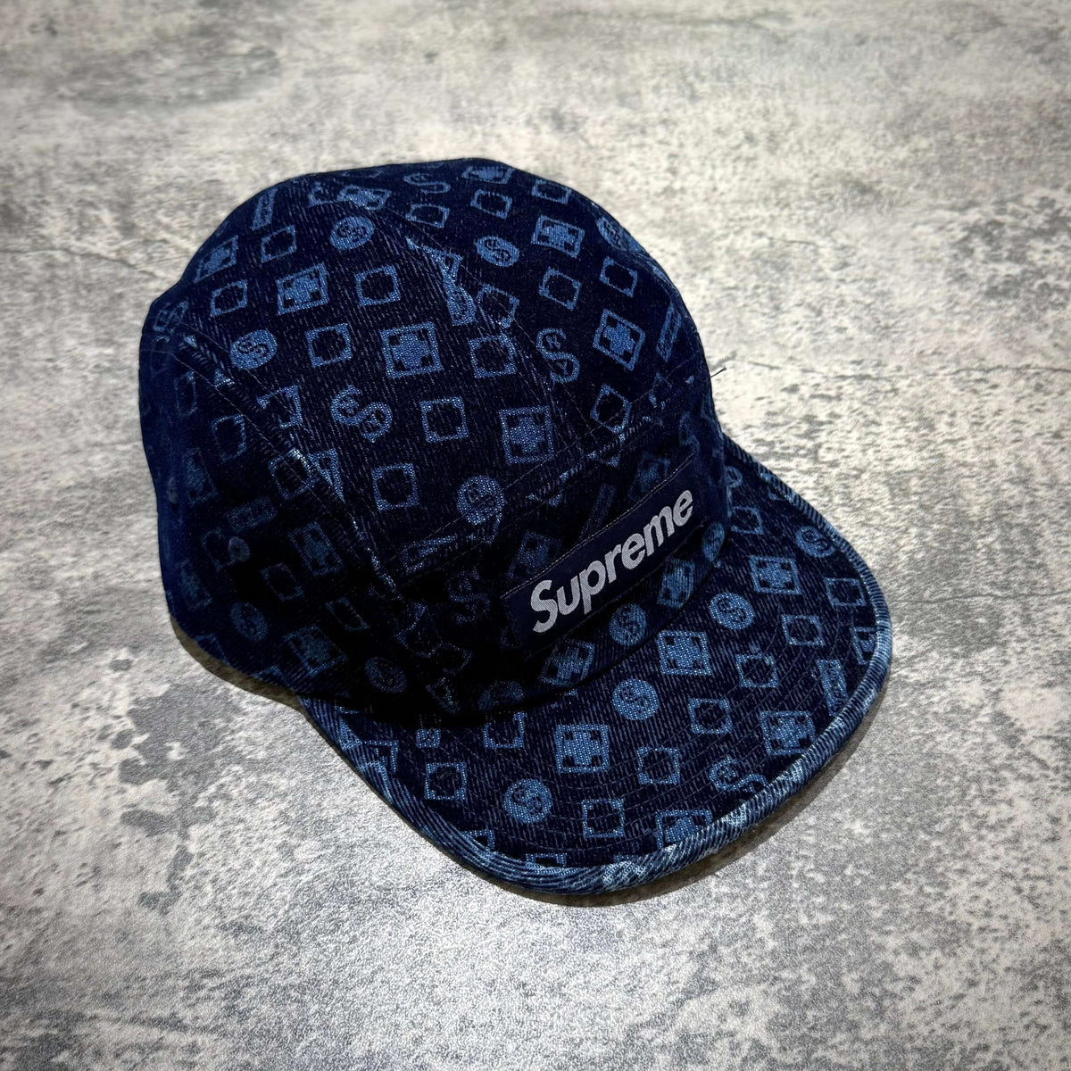 Supreme Flocked Denim Camp Cap featuring a unique patterned design and logo.