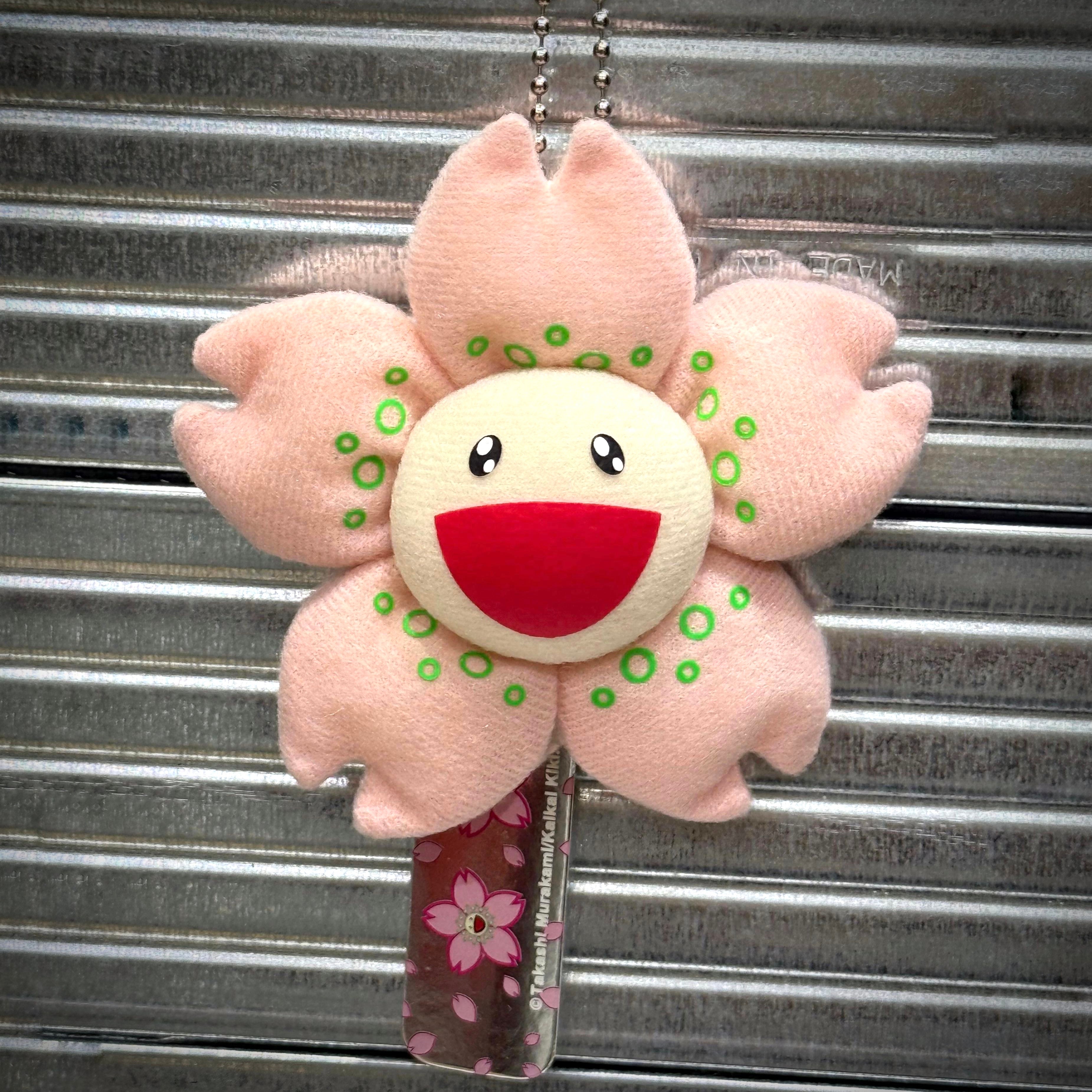 Takashi Murakami Cherry Blossom 8cm Plush Pin featuring a pink flower with a smiling face.