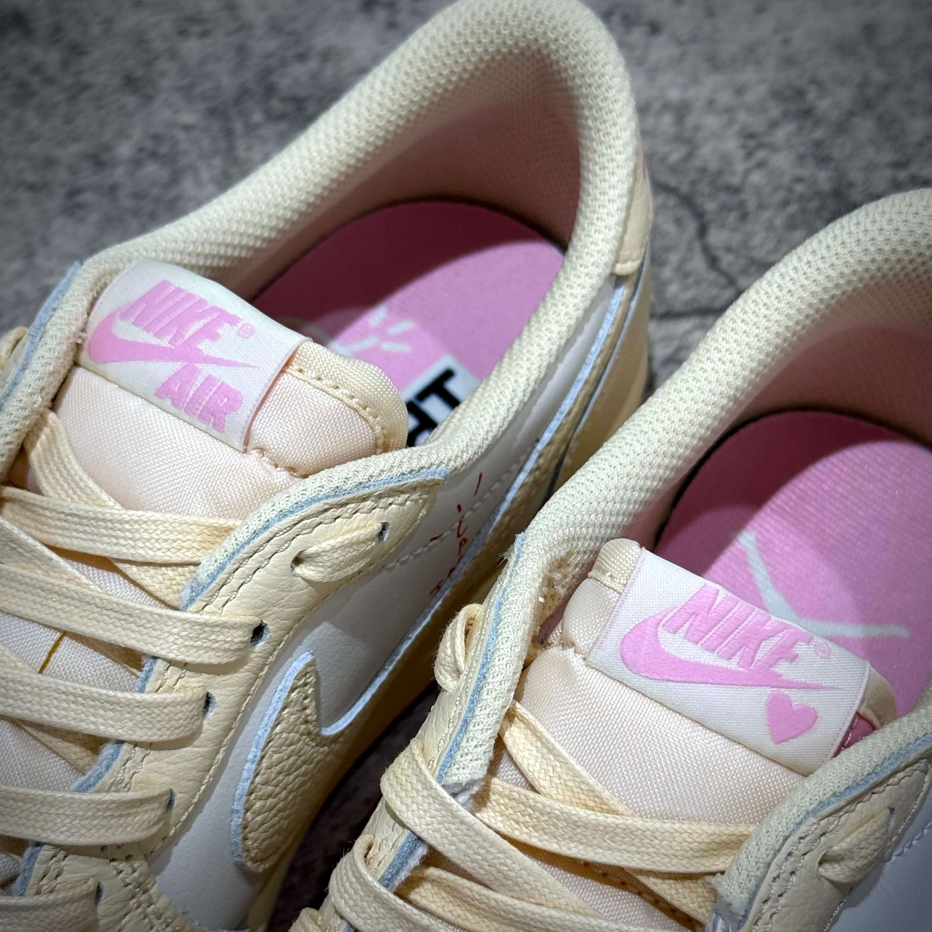 Travis Scott × Nike Air Jordan 1 Retro Low SP - Shy Pink close-up showing beige and pink colorway details.