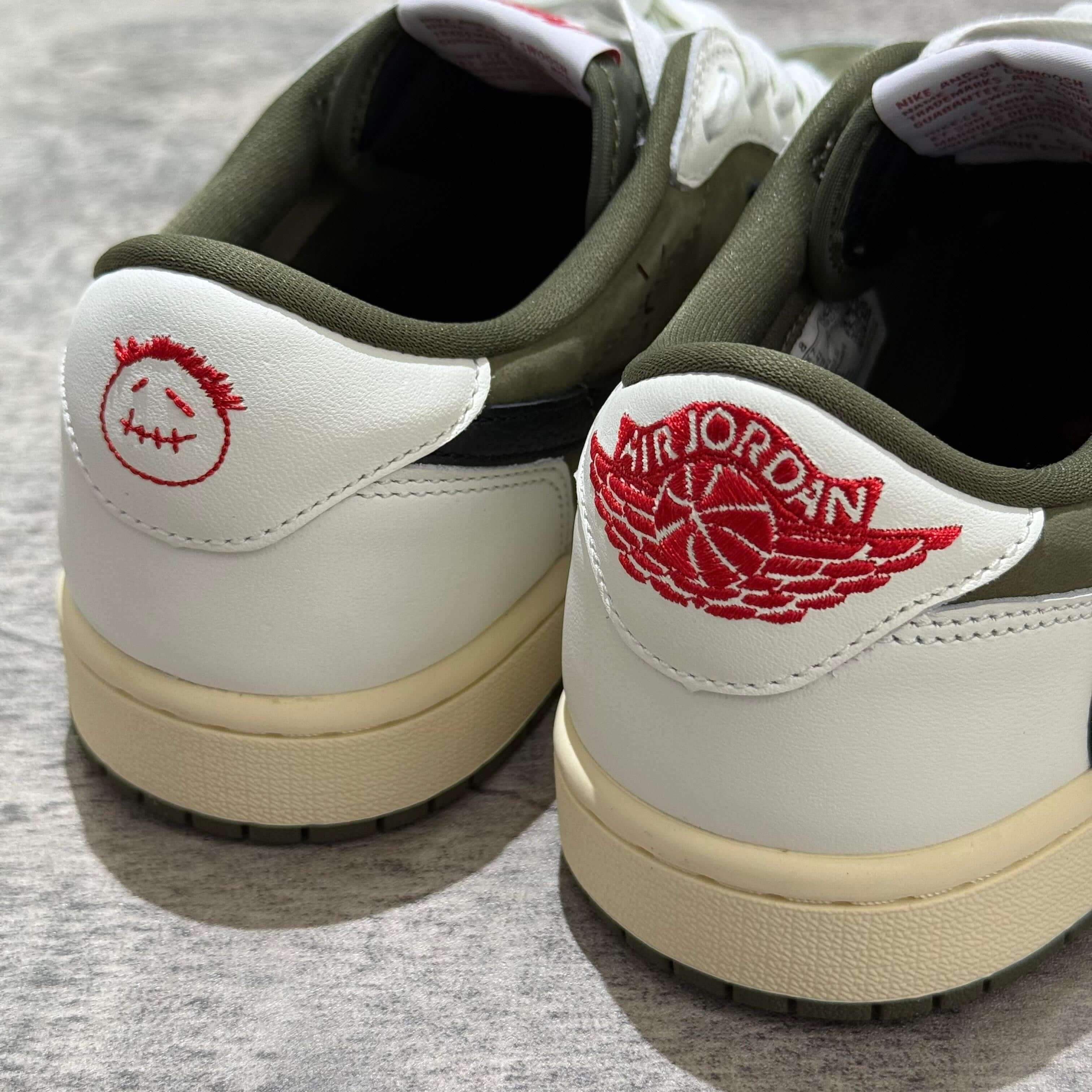 Travis Scott x Air Jordan 1 Low 8.0 Medium Olive sneaker back view featuring embroidered branding and unique design.