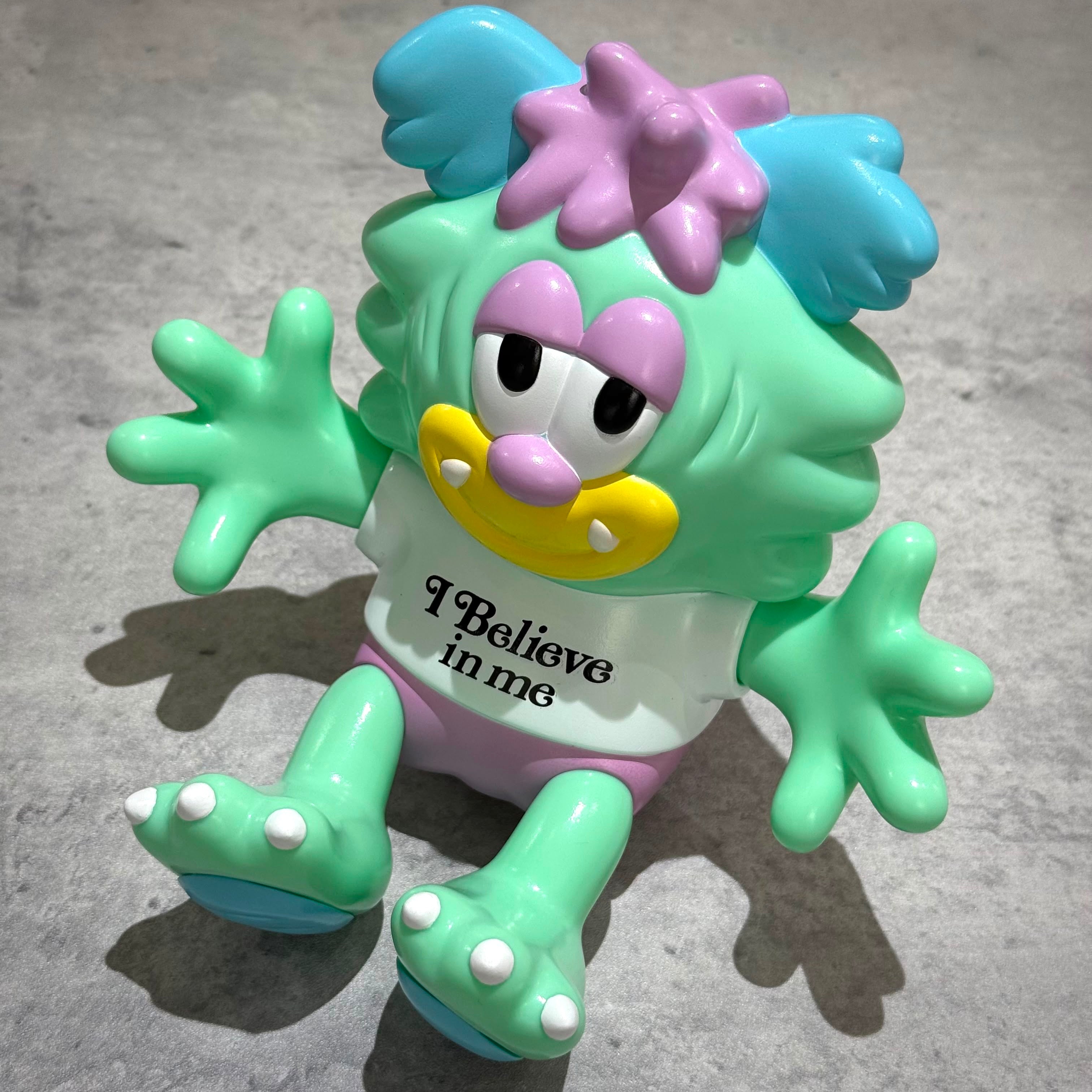 Verdy x Lotte Museum Visty Figure in green with blue and pink accents, displaying 'I Believe in me' on its shirt.