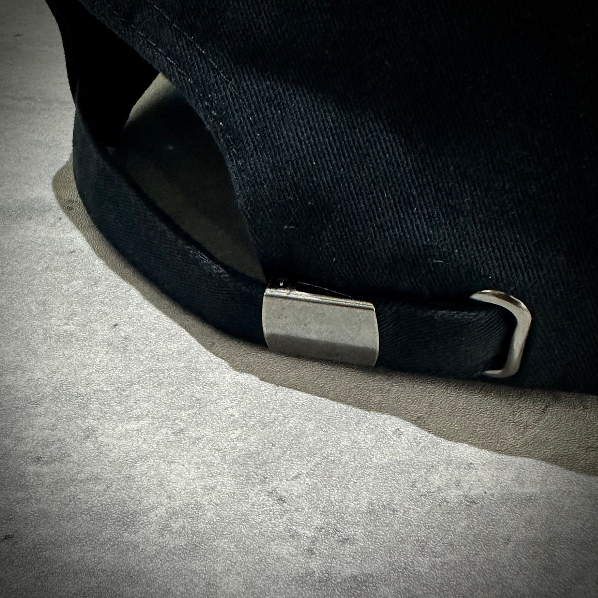 Close-up of the adjustable strap on the Wild Things x Mastermind World Tee Cap, showcasing its durable design.